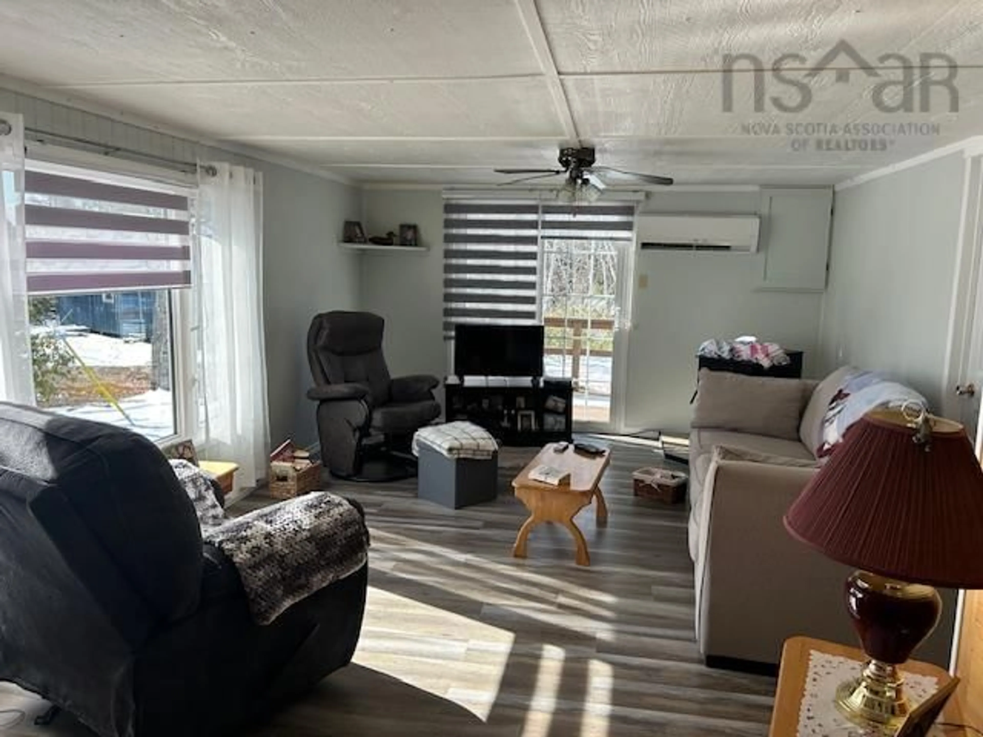 Living room with furniture, wood/laminate floor for 2379 Upper Clyde Rd, Clyde River Nova Scotia B0W 1R0