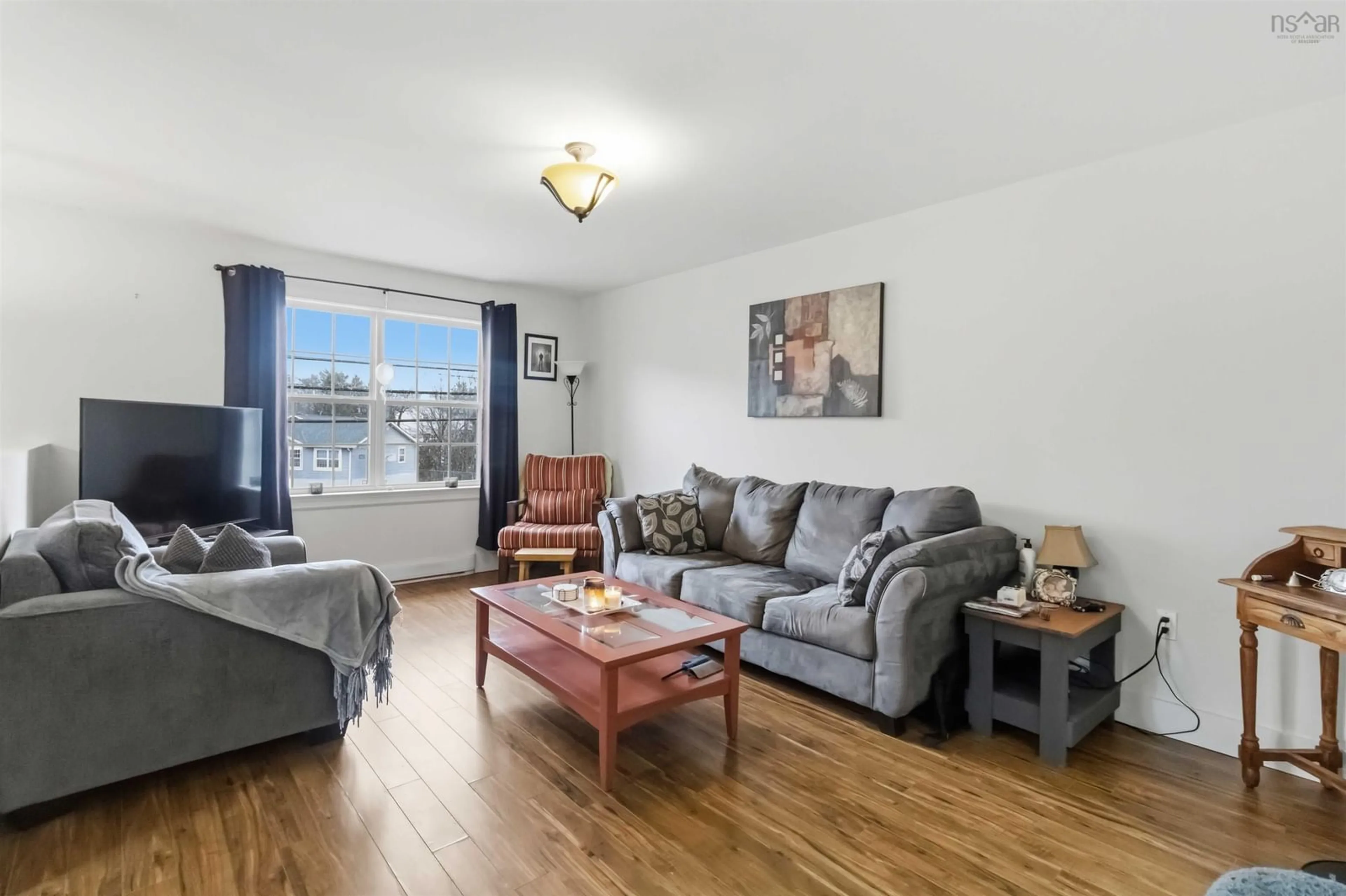 Living room with furniture, wood/laminate floor for 928 Sackville Dr, Middle Sackville Nova Scotia B4E 1S4