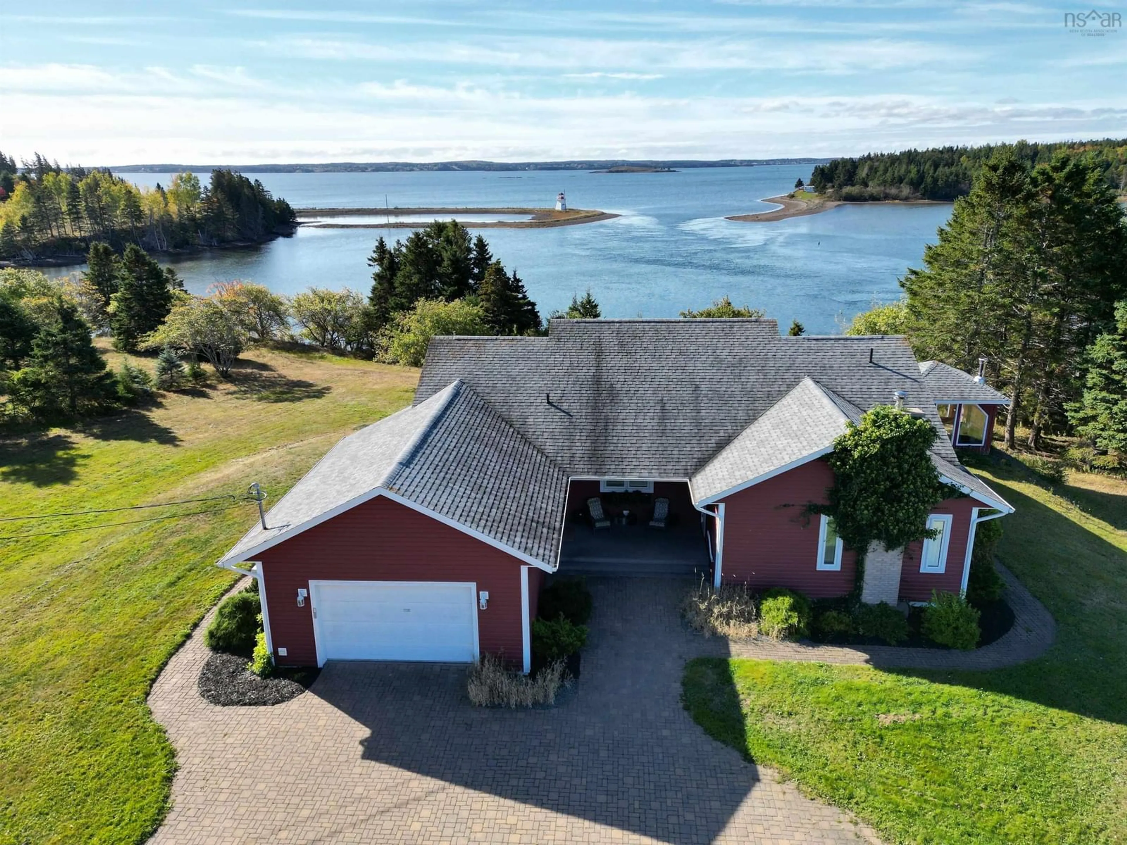 A pic from outside/outdoor area/front of a property/back of a property/a pic from drone, water/lake/river/ocean view for 11 Wharf Rd, River Bourgeois Nova Scotia B0E 2X0