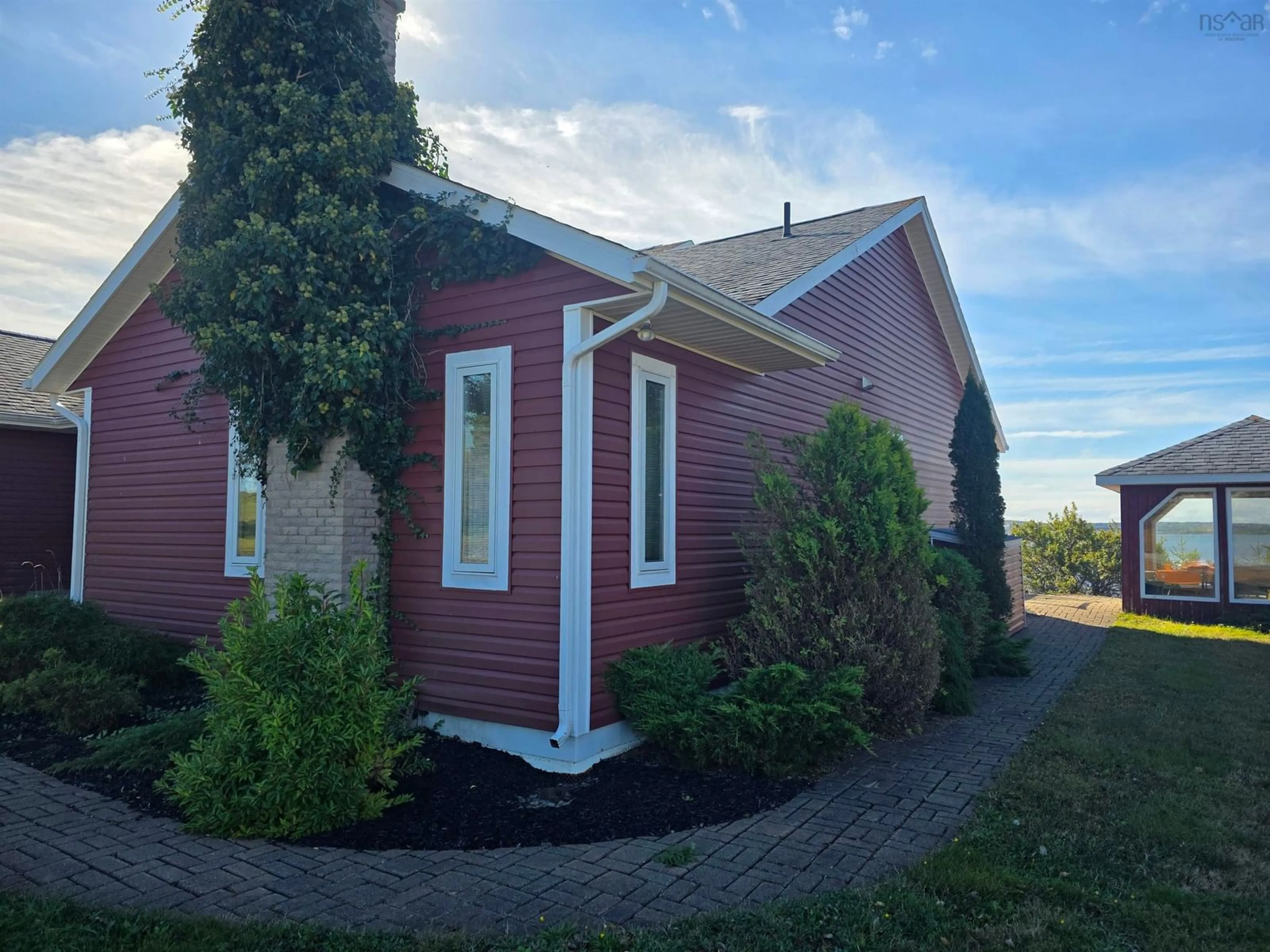 Home with vinyl exterior material, street for 11 Wharf Rd, River Bourgeois Nova Scotia B0E 2X0