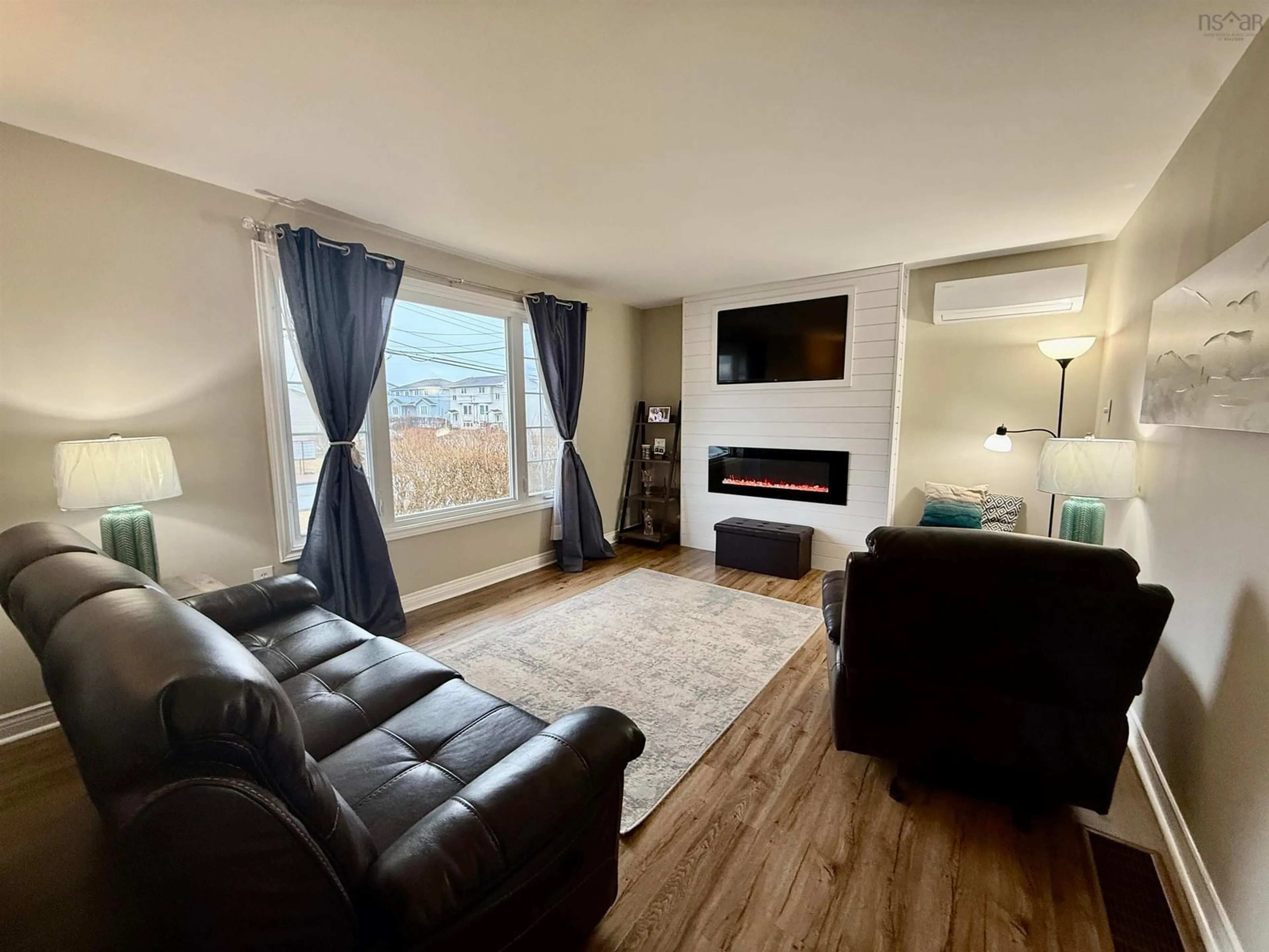 Living room with furniture, wood/laminate floor for 26 Romkey Dr, Eastern Passage Nova Scotia B3G 1G9