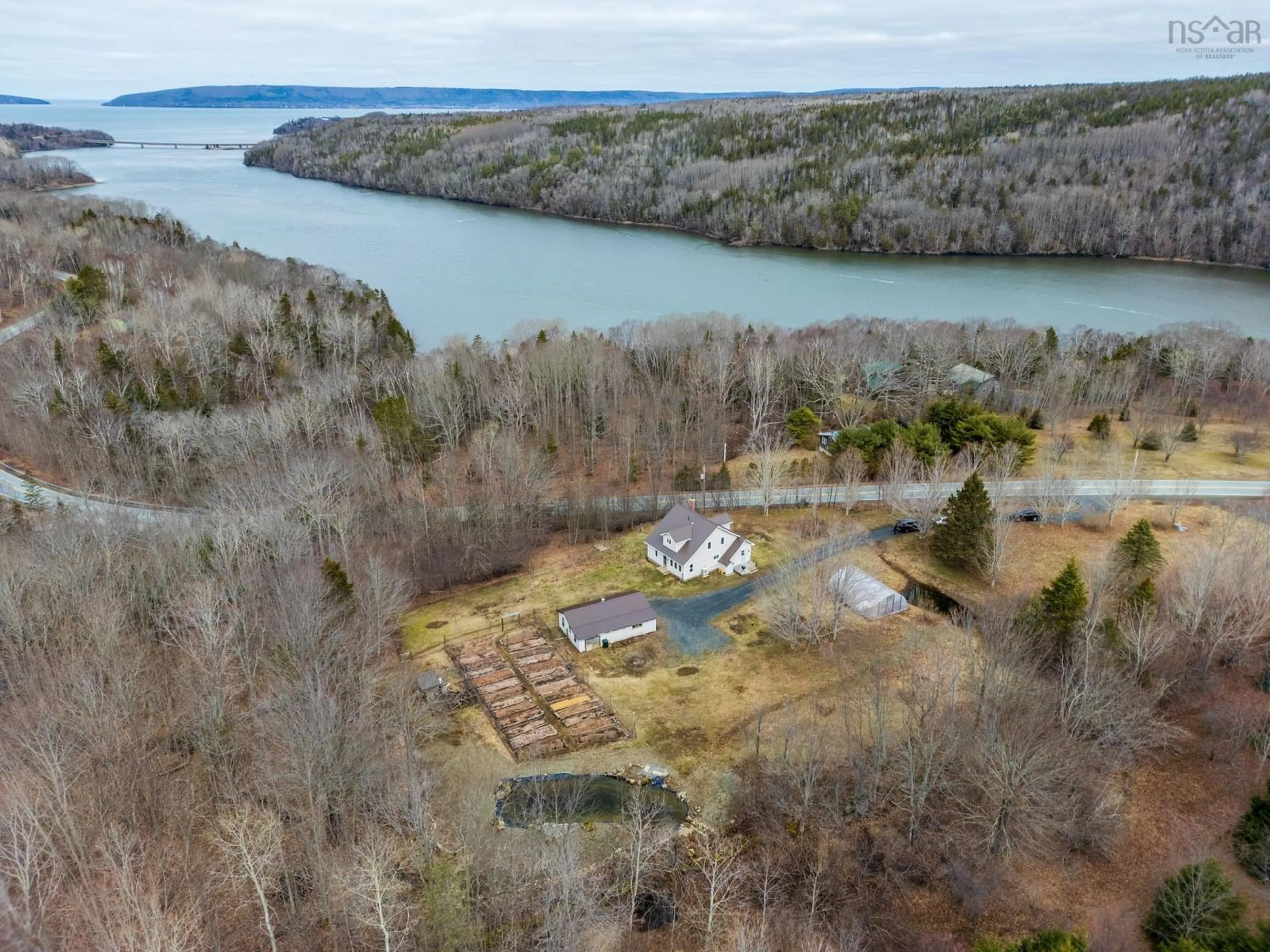 A pic from outside/outdoor area/front of a property/back of a property/a pic from drone, water/lake/river/ocean view for 550 River Rd, Bear River Nova Scotia B0S 1B0