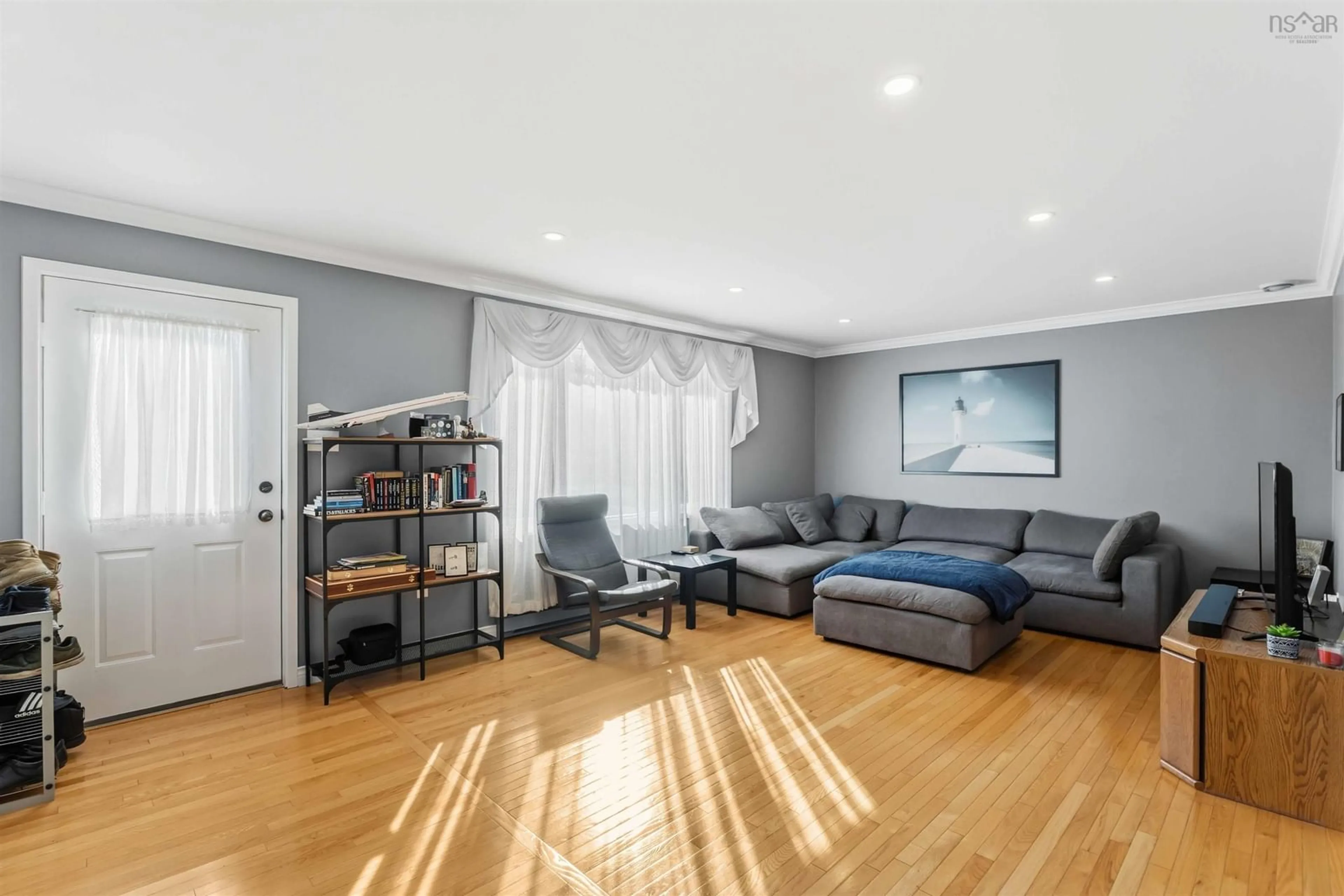 Living room with furniture, wood/laminate floor for 955 Labrador Lane, Greenwood Nova Scotia B0P 1N0