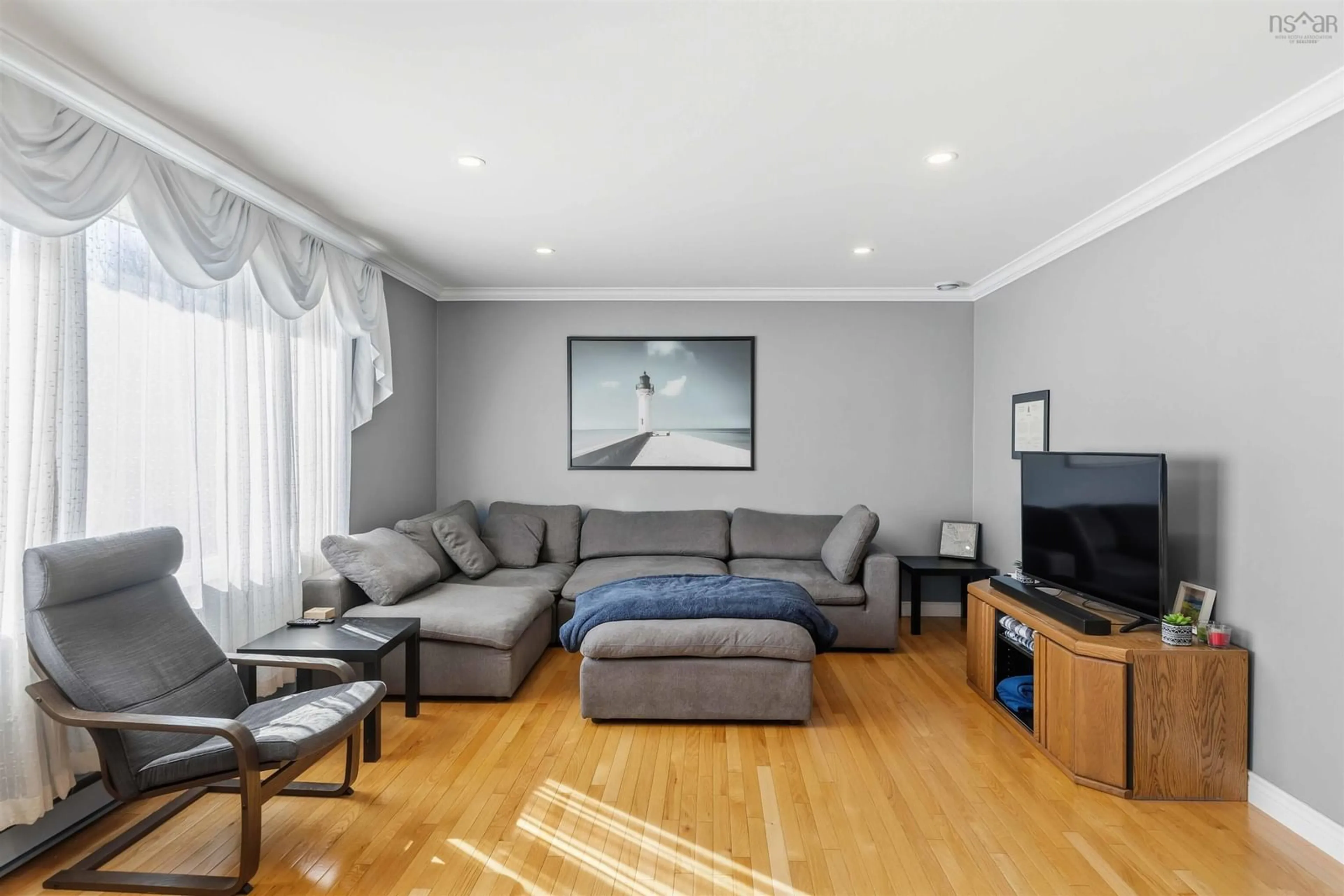 Living room with furniture, wood/laminate floor for 955 Labrador Lane, Greenwood Nova Scotia B0P 1N0