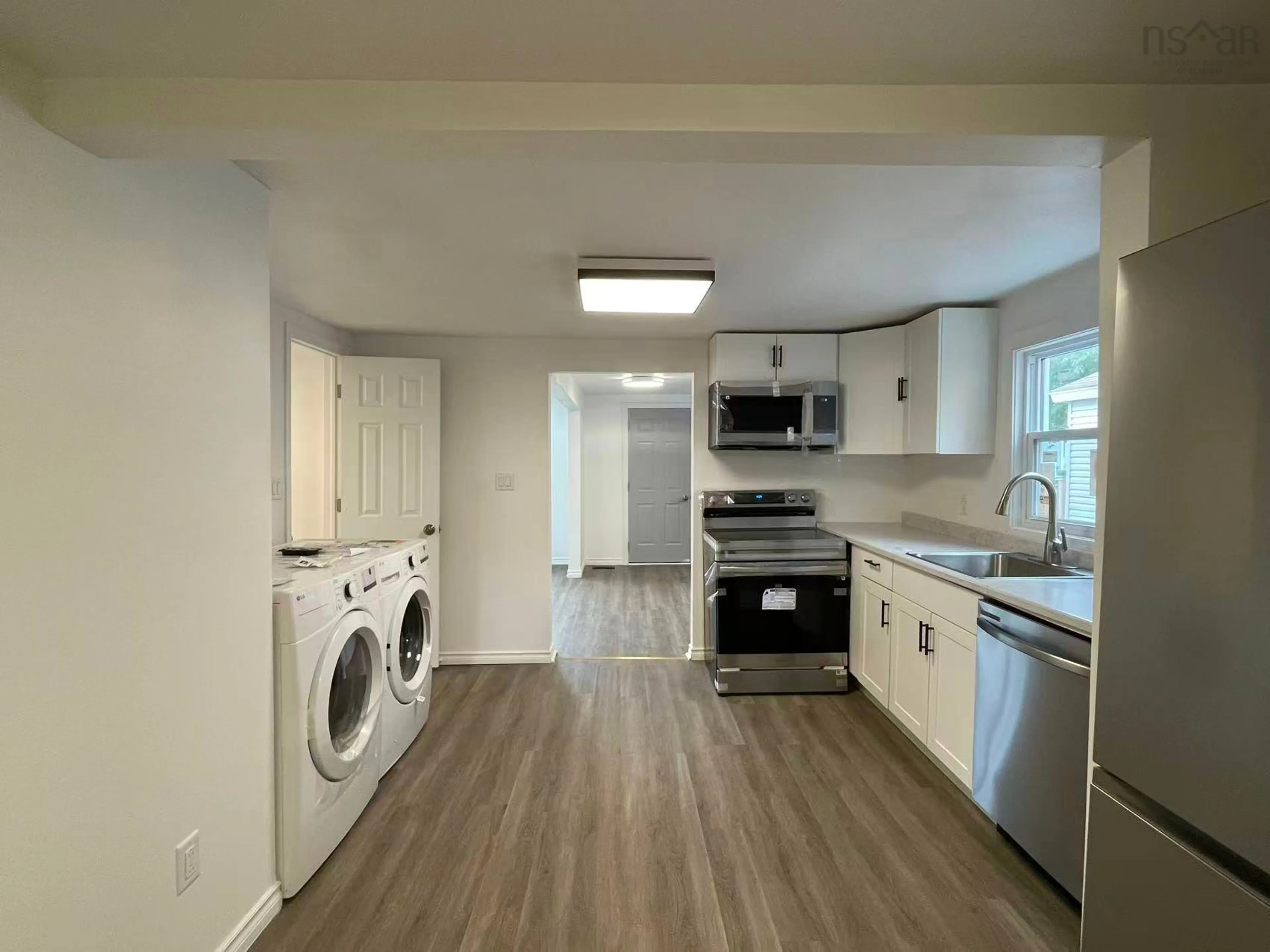 Kitchen with laundary machines, unknown for 123 Lorne St, Sydney Nova Scotia B1P 4H3