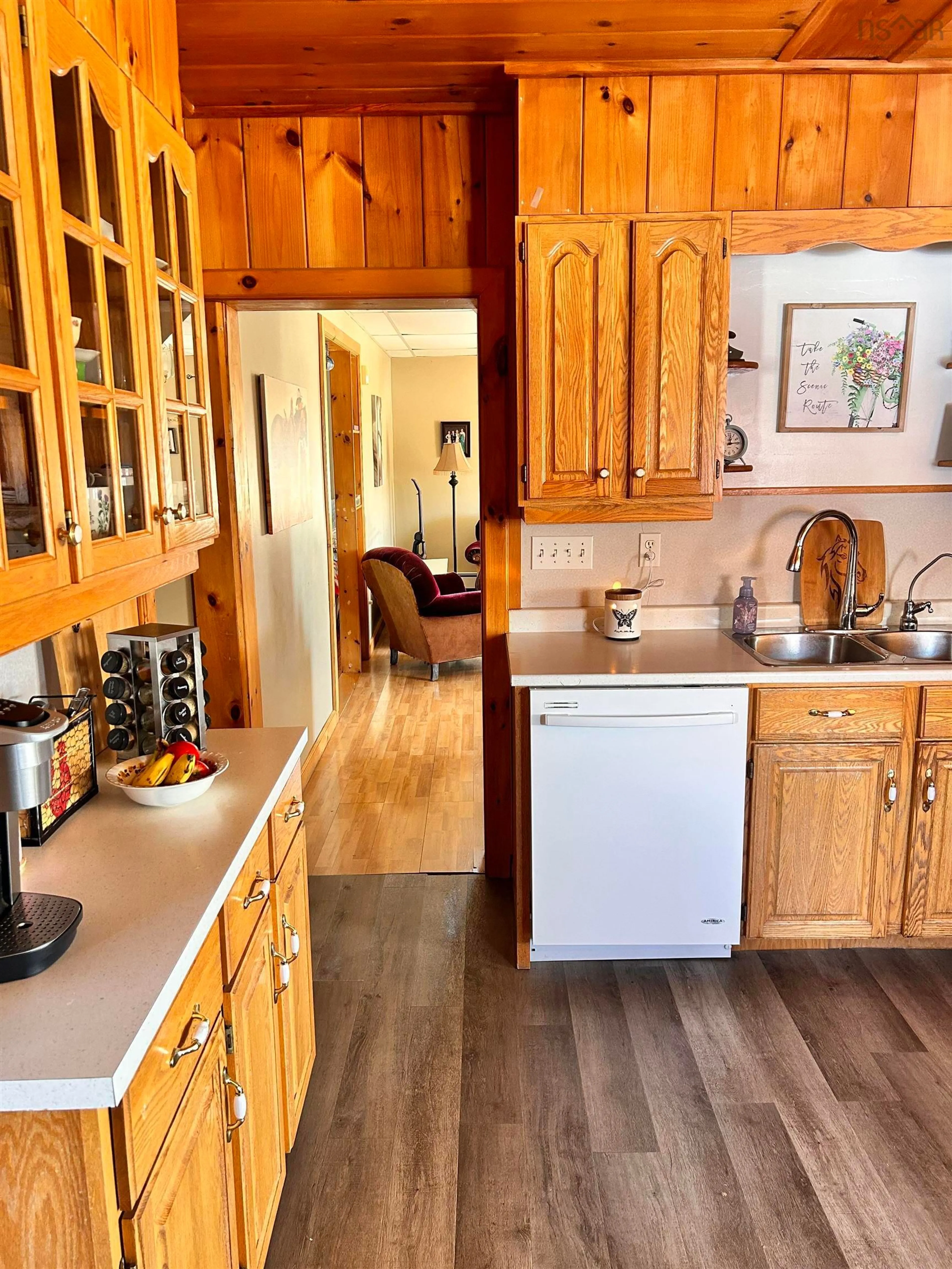 Open concept kitchen, wood/laminate floor for 2041 Strathlorne-Scotsville Rd, North Ainslie Nova Scotia B0E 3M0