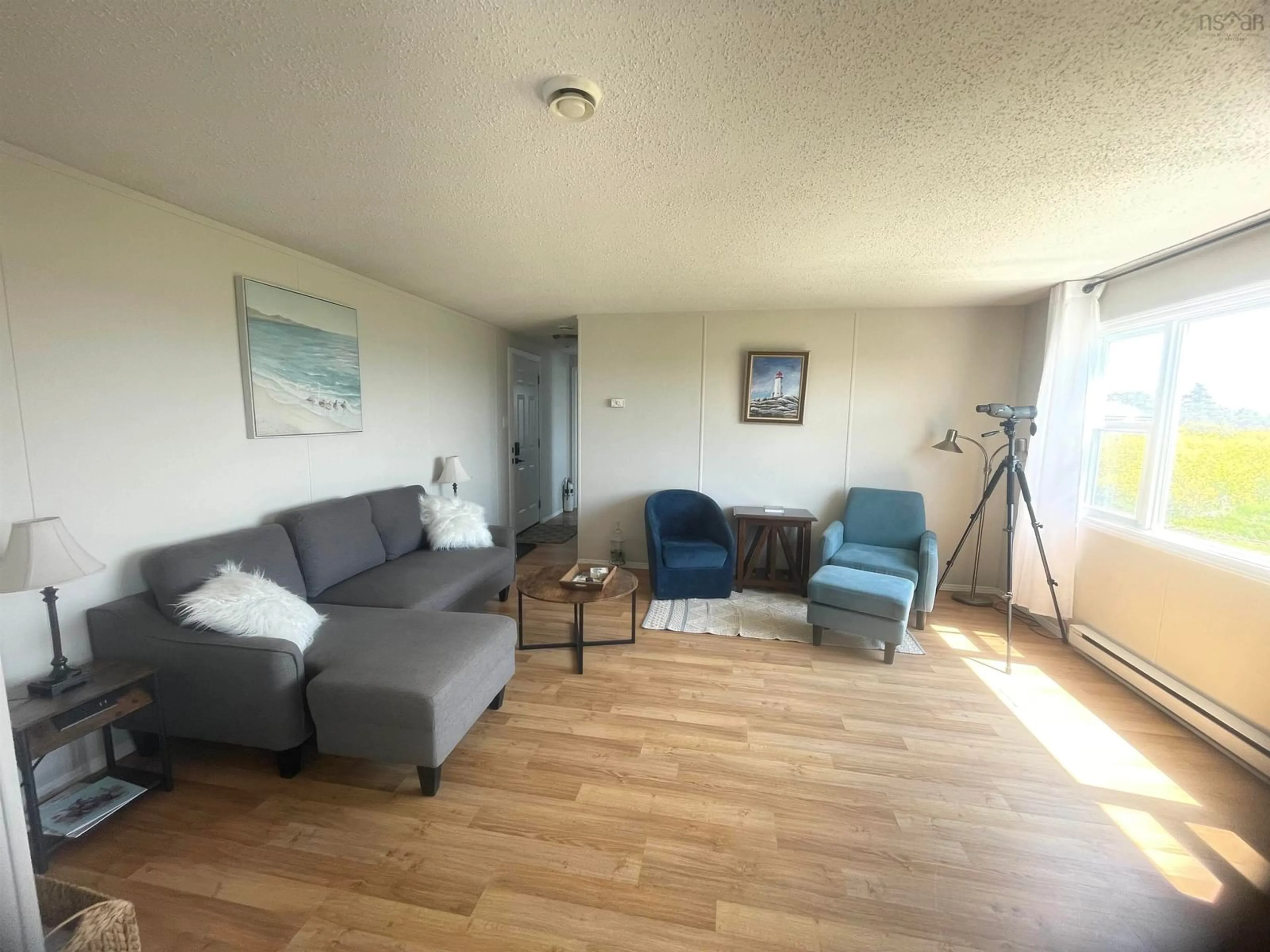 Living room with furniture, wood/laminate floor for 72 Smith Lane, Lower Clarks Harbour Nova Scotia B0W 1P0
