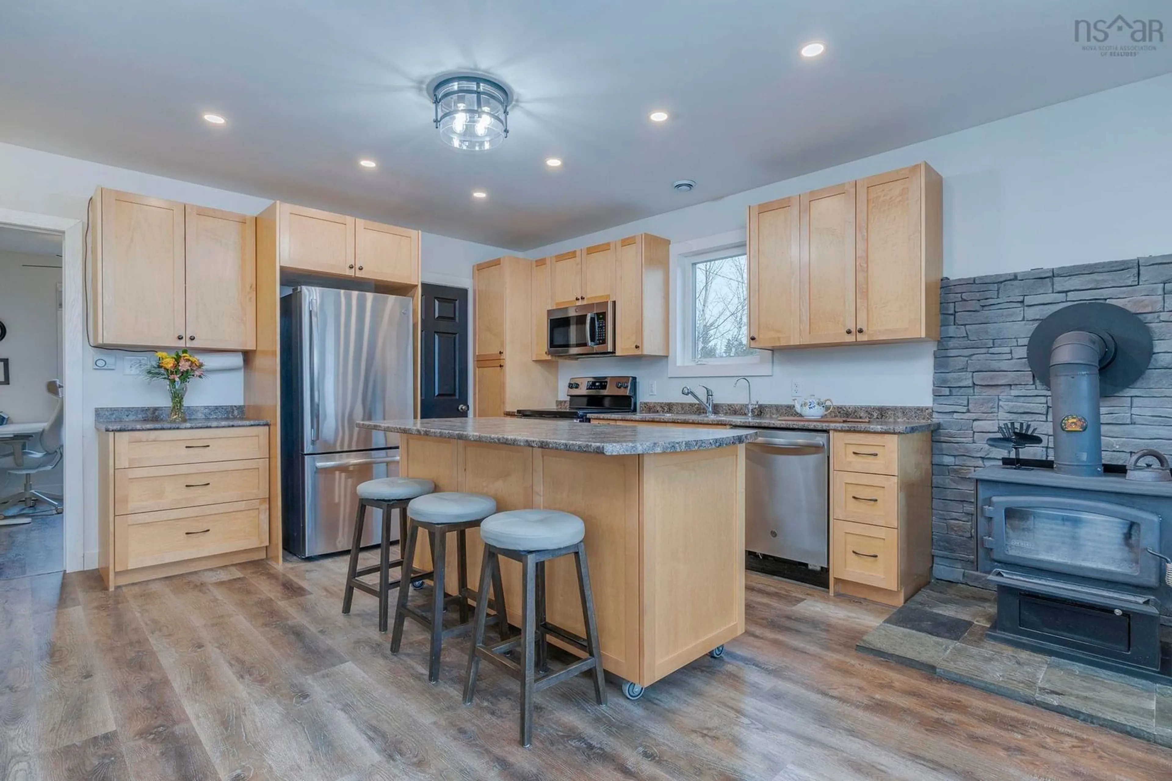 Open concept kitchen, wood/laminate floor for 1588 Myra Rd, Porters Lake Nova Scotia B3E 1H1