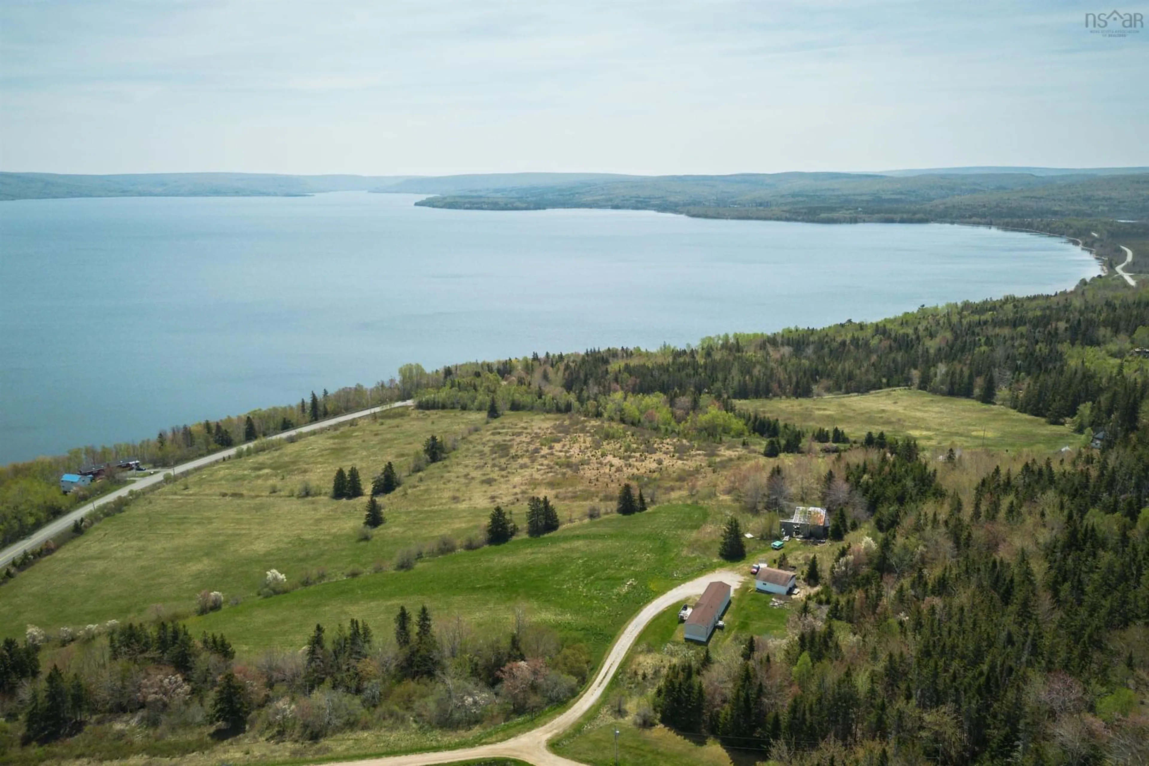 A pic from outside/outdoor area/front of a property/back of a property/a pic from drone, water/lake/river/ocean view for 1576 West Lake Ainslie Rd, West Lake Ainslie Nova Scotia B0E 1N0