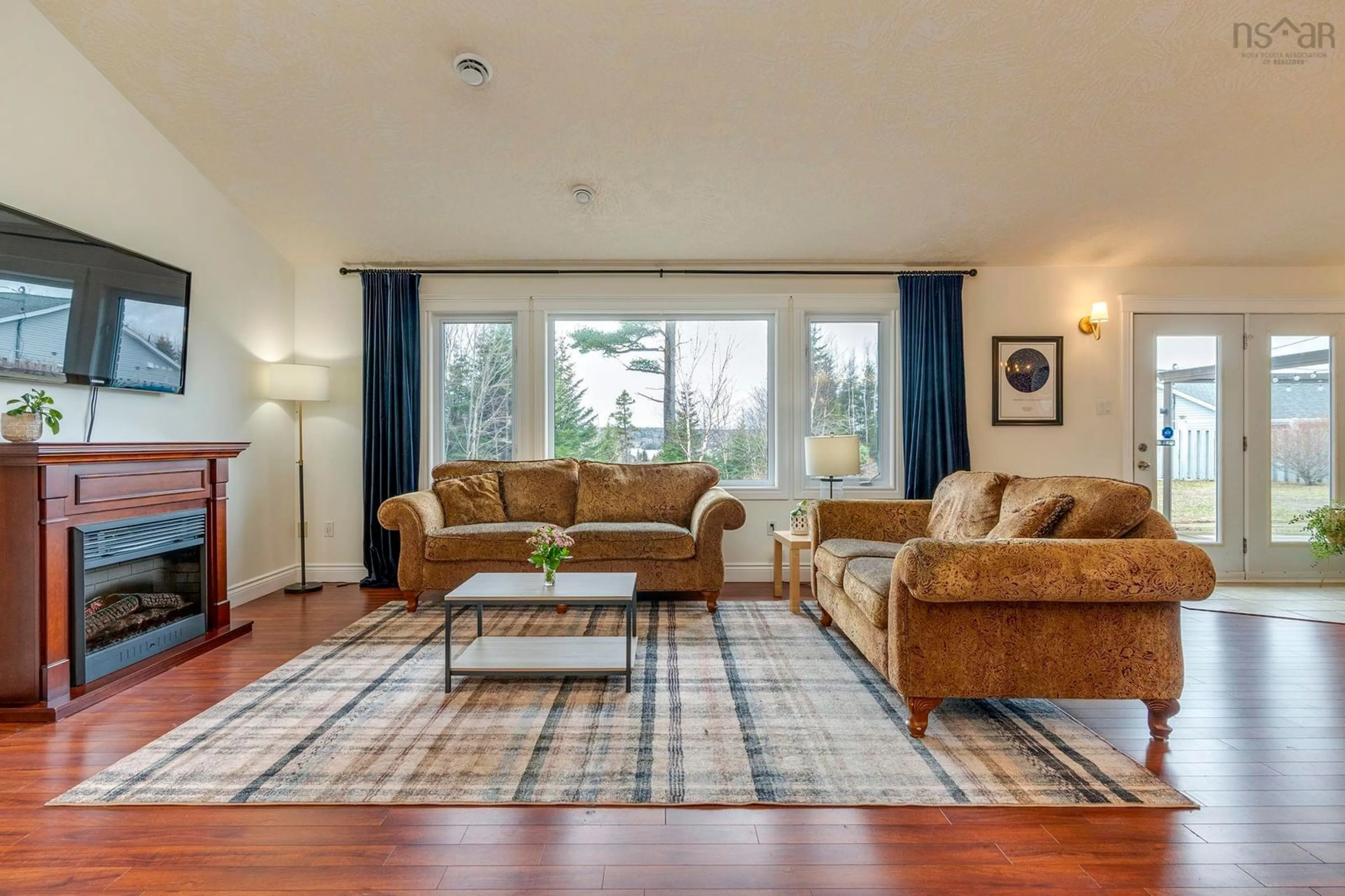 Living room with furniture, wood/laminate floor for 51 Sandy Point Rd, Porters Lake Nova Scotia B3E 1M9