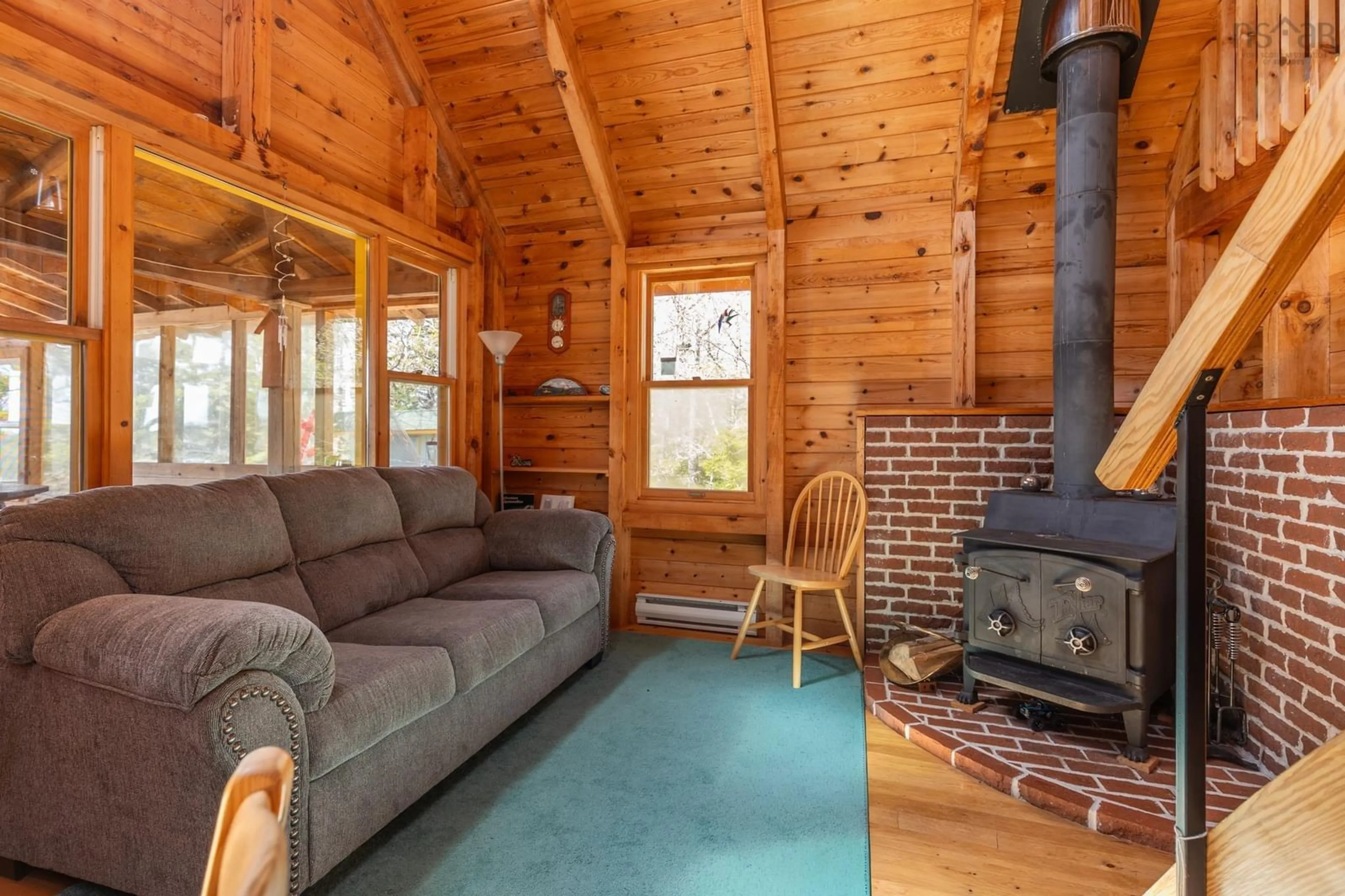 Living room with furniture, wood/laminate floor for 616 Lac A Pic Rd, Quinan Nova Scotia B0W 3M0