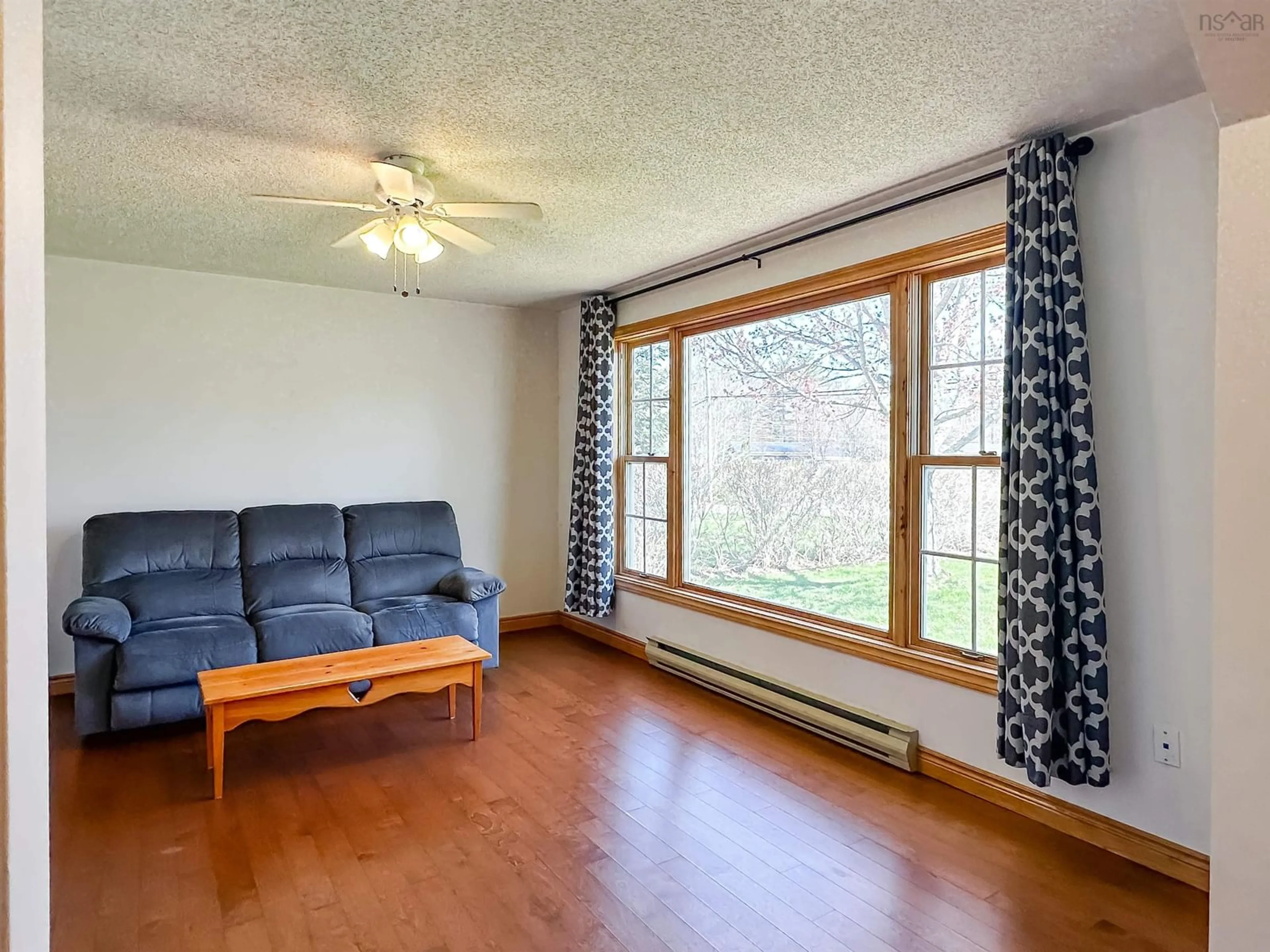 Living room with furniture, wood/laminate floor for 2630 Poplar Dr, Coldbrook Nova Scotia B4R 1B1