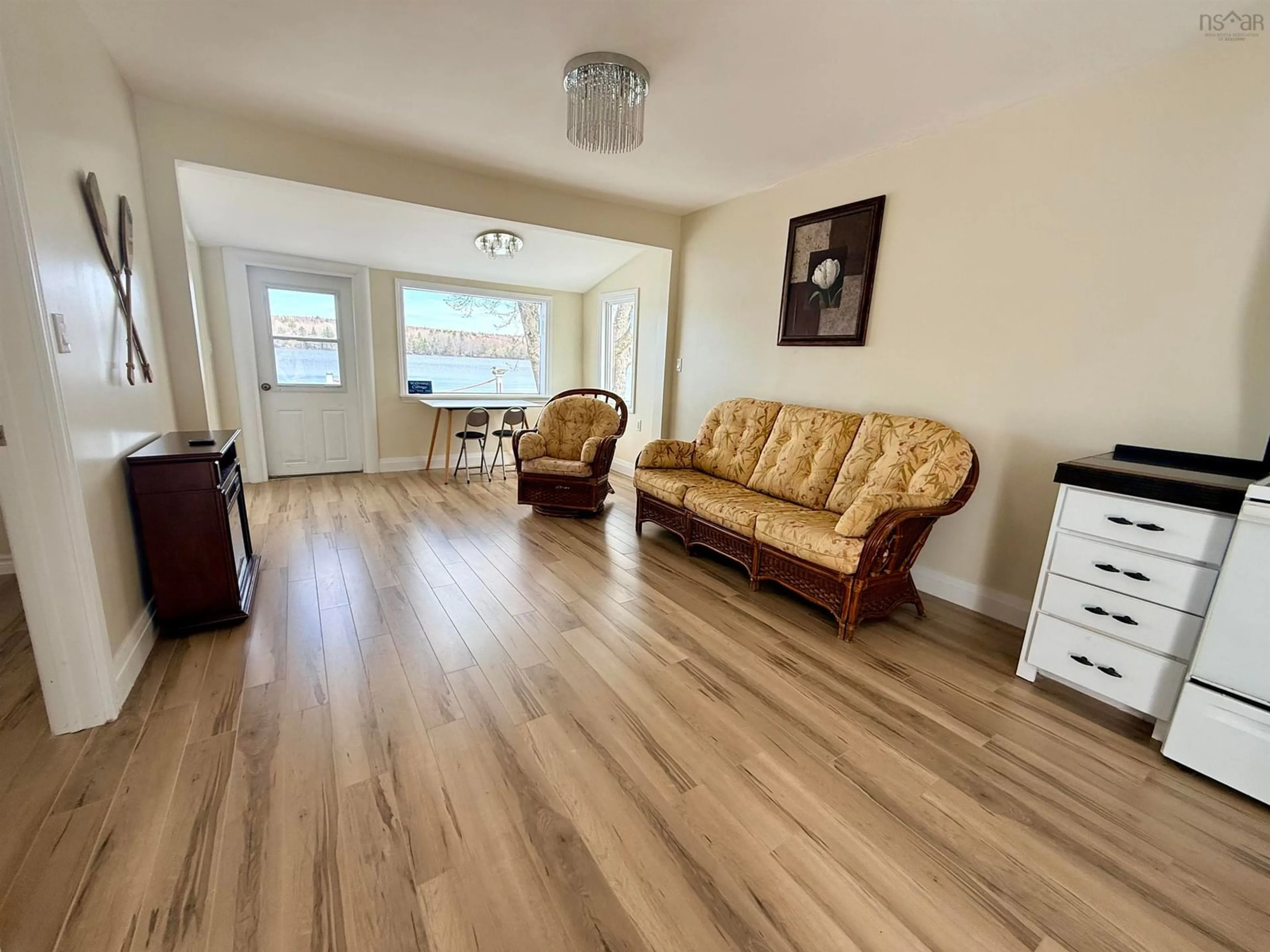 Living room with furniture, wood/laminate floor for 4874 Highway 340, Carleton Nova Scotia B5A 5P9