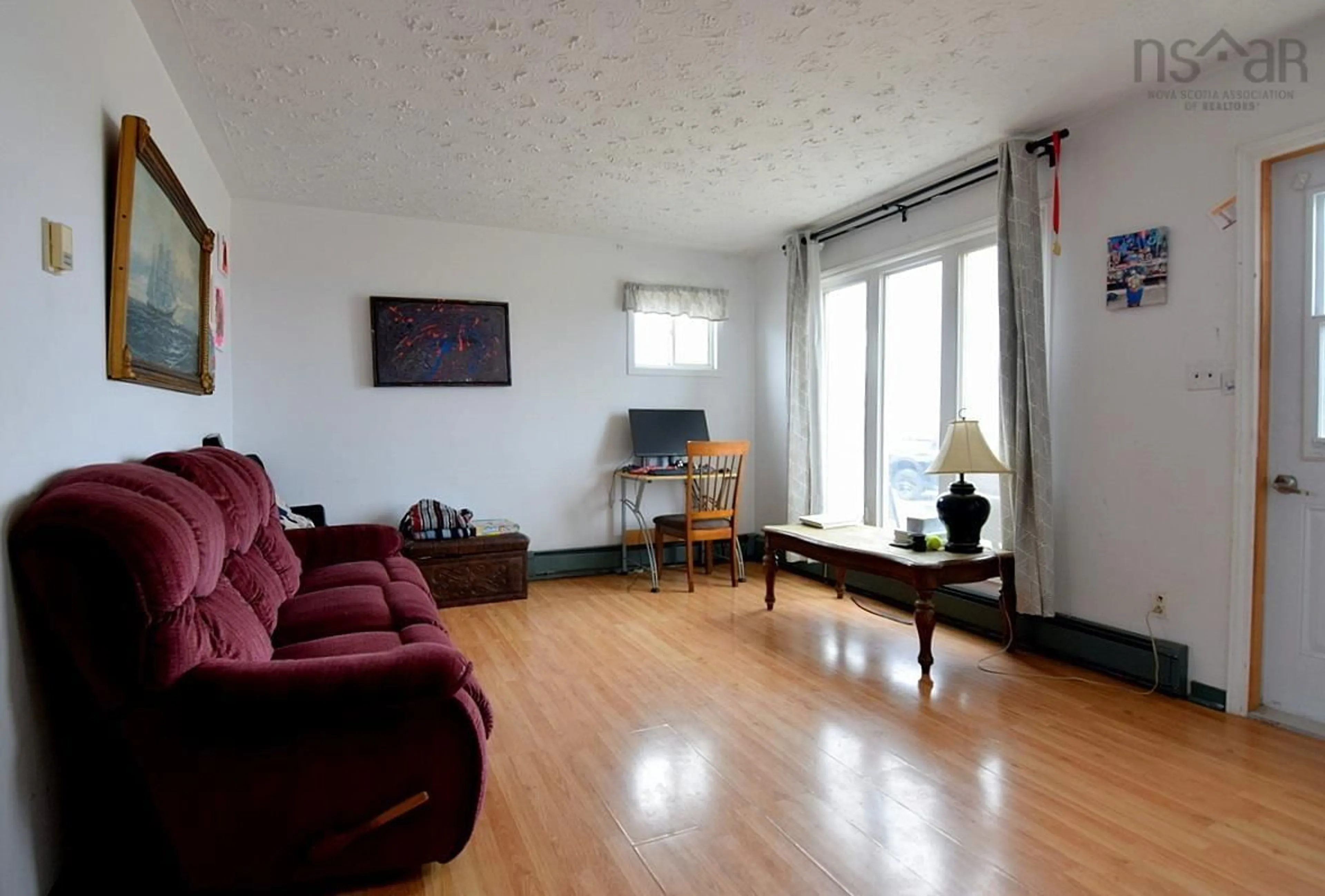 Living room with furniture, wood/laminate floor for 15996 Central Ave, Inverness Nova Scotia B0E 1N0
