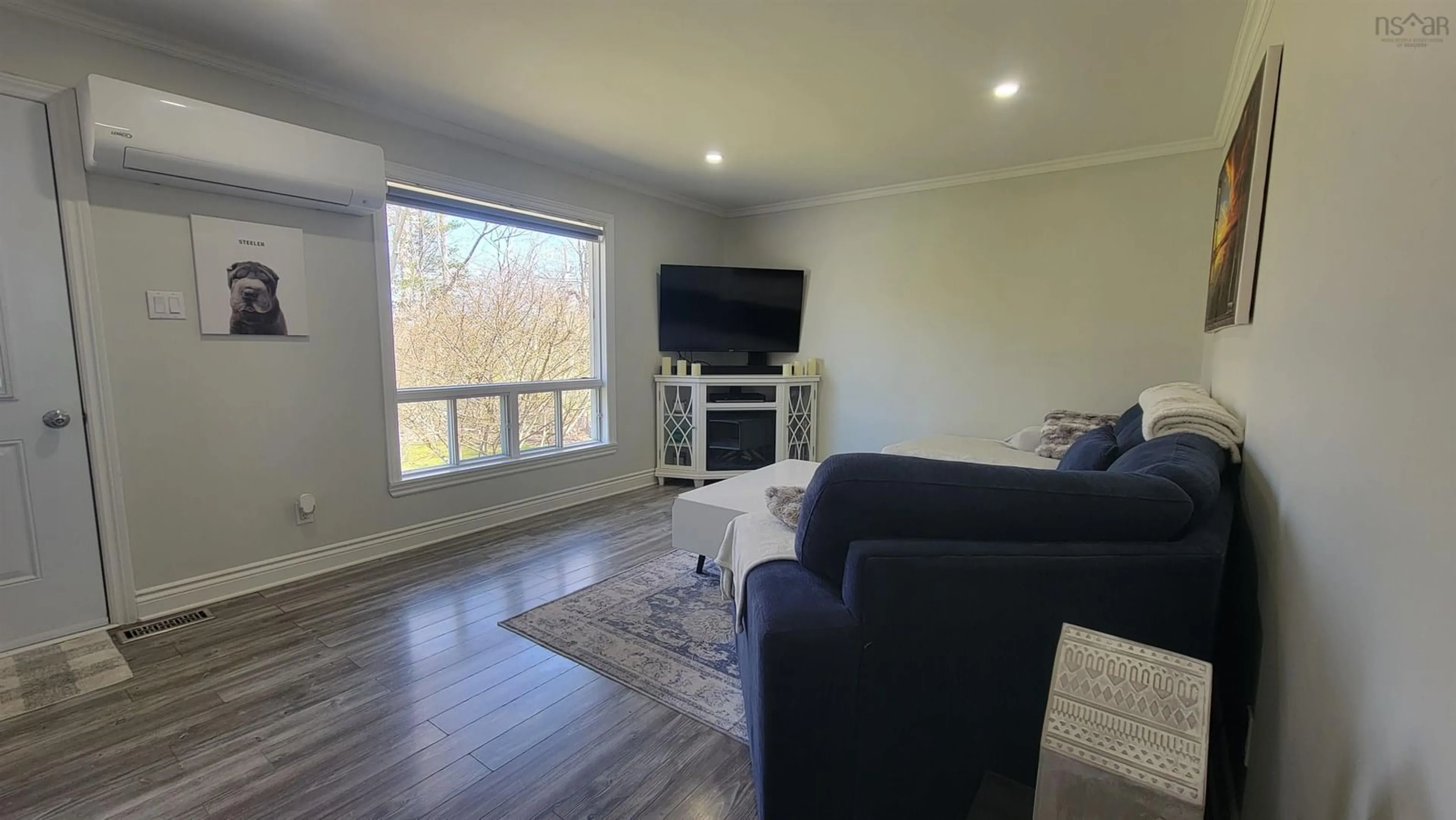 Living room with furniture, wood/laminate floor for 202 Saunders Rd, Deerfield Nova Scotia B5A 5N6