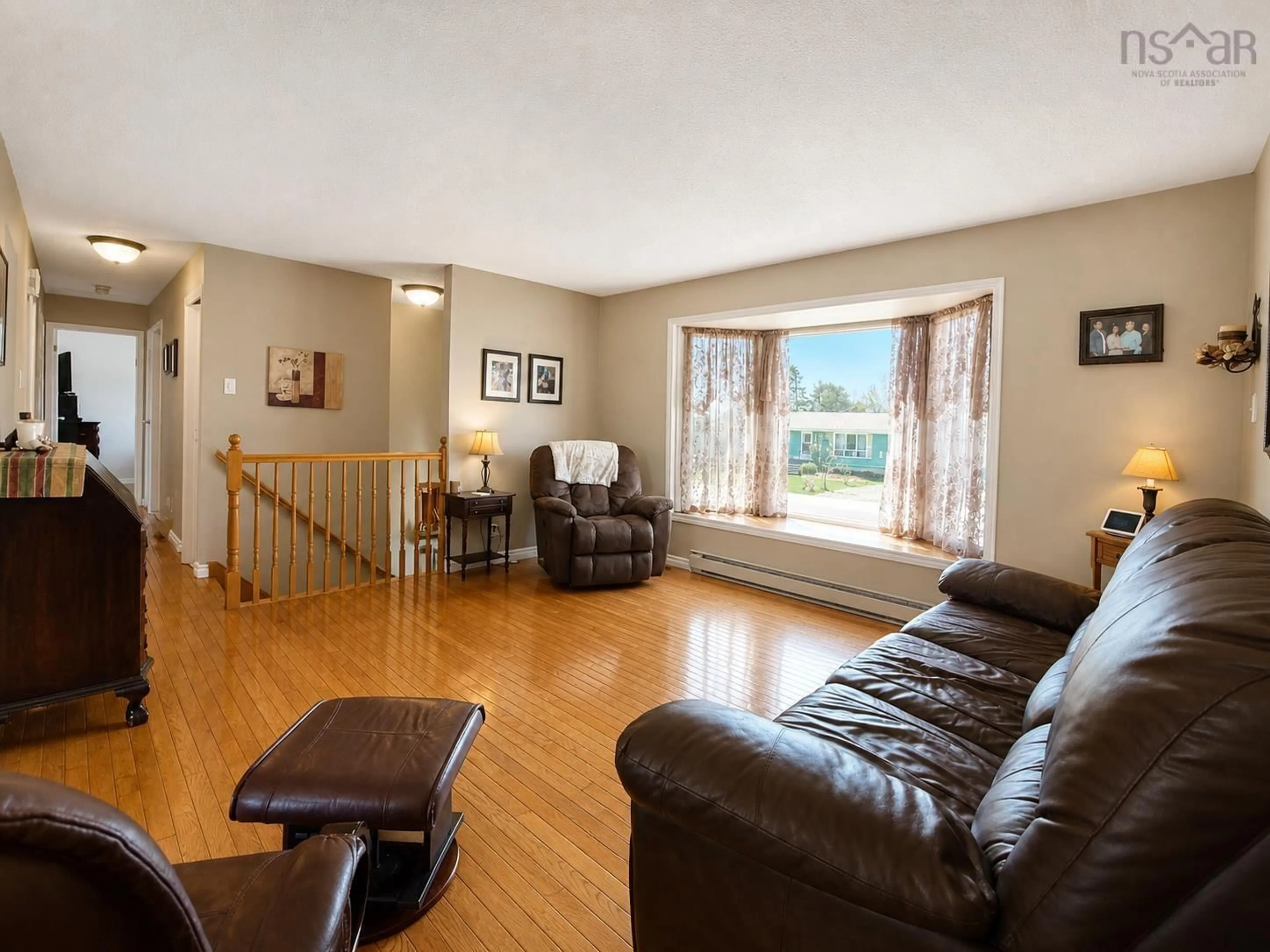 Living room with furniture, wood/laminate floor for 40 James St, Yarmouth Nova Scotia B5A 4M5