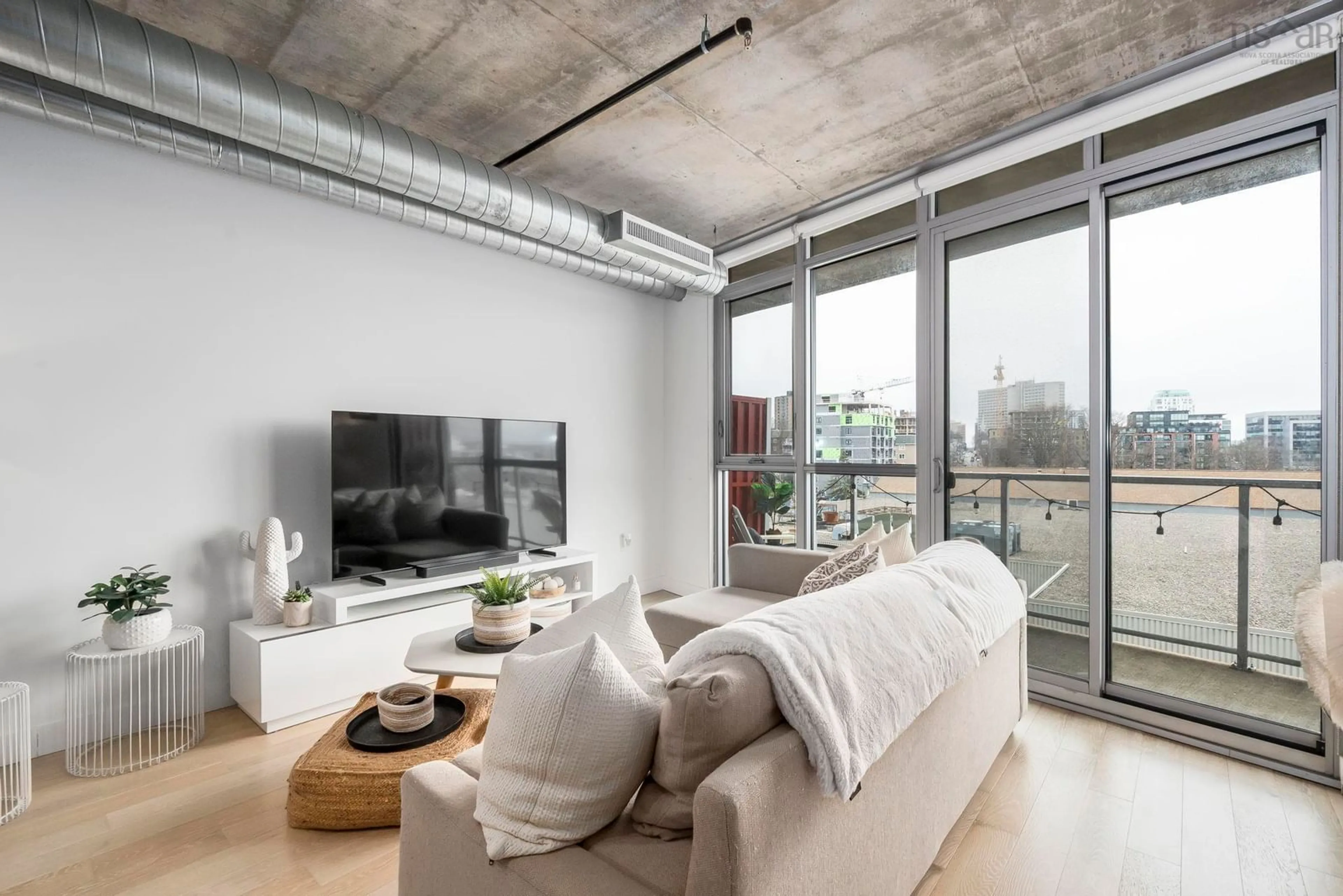 Living room with furniture, cement floor for 1065 Barrington St #504, Halifax Nova Scotia B3H 2P8