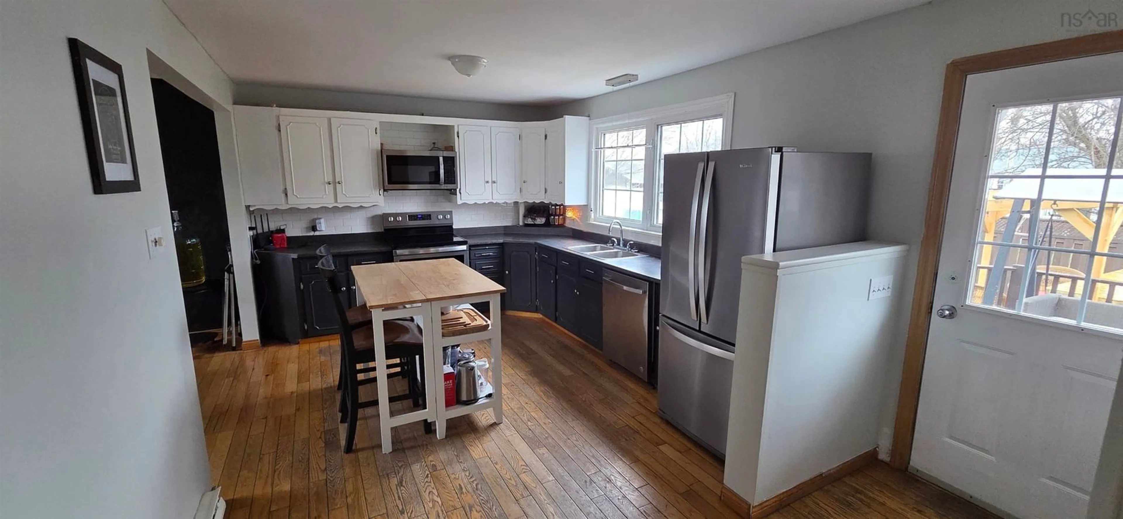 Open concept kitchen, wood/laminate floor for 158 Kennedy Ave, Sydney Nova Scotia B1P 3K8