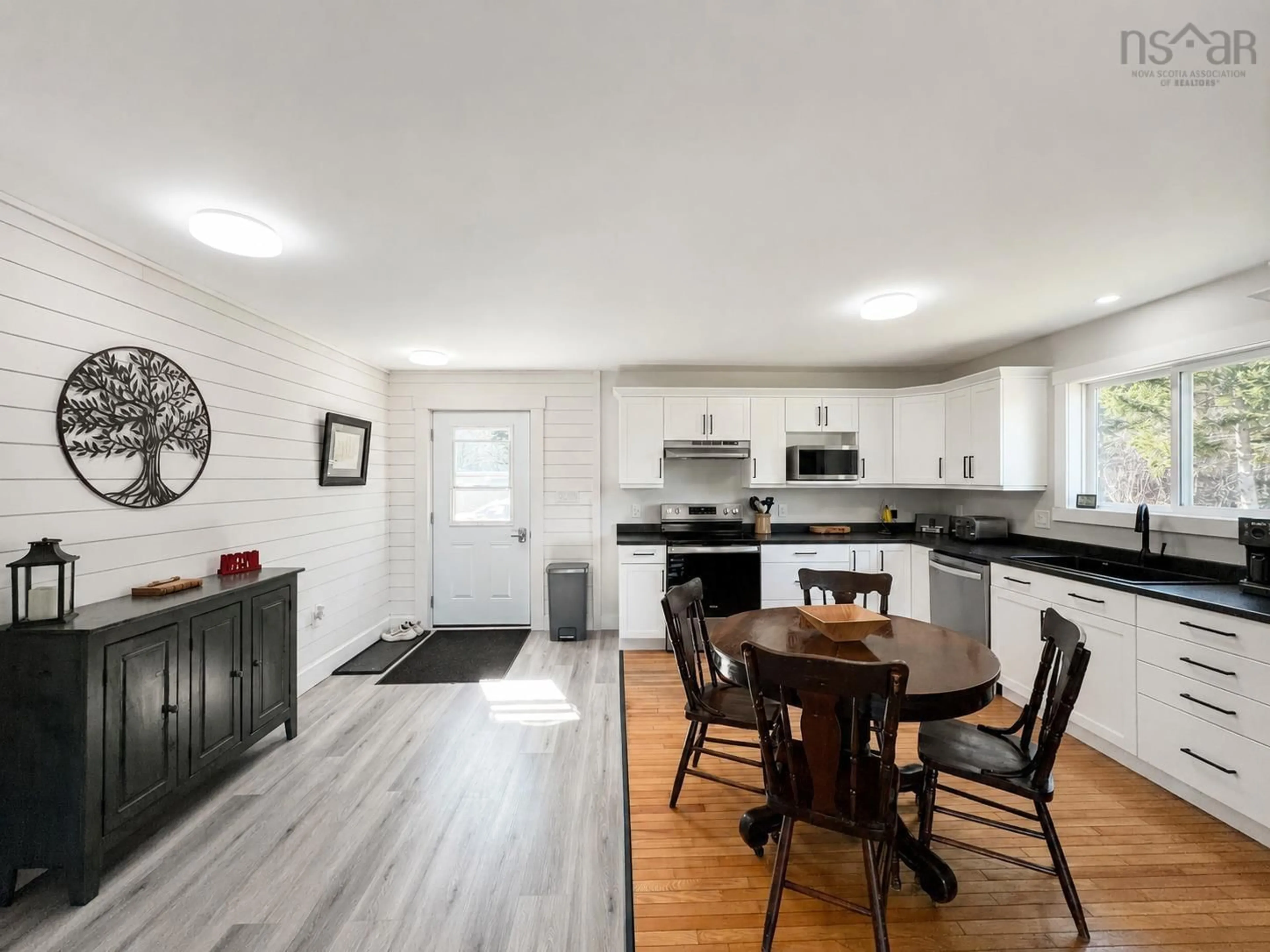 Open concept kitchen, wood/laminate floor for 8361 Cabot Trail, Margaree Forks Nova Scotia B0E 2A0