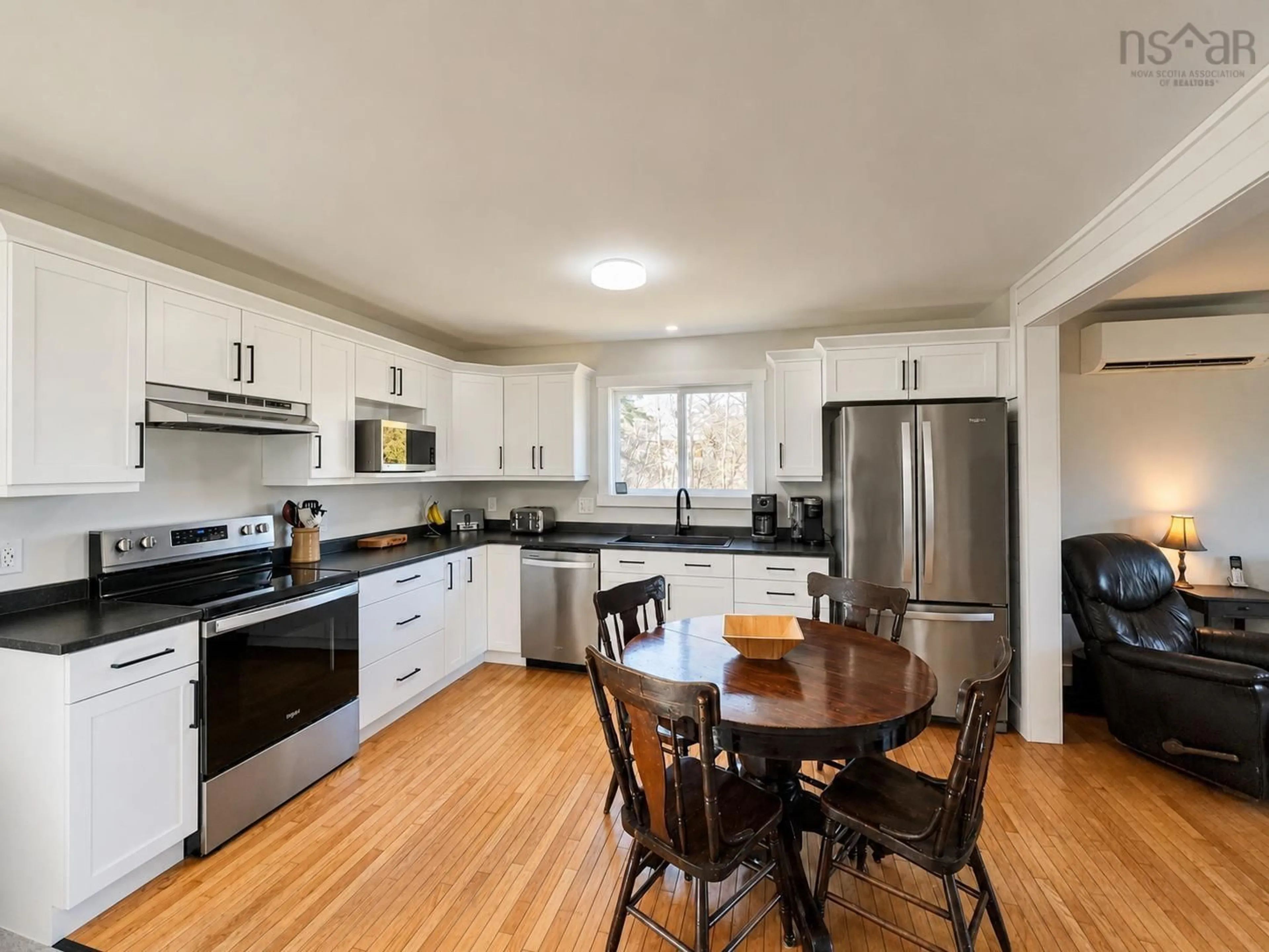 Open concept kitchen, wood/laminate floor for 8361 Cabot Trail, Margaree Forks Nova Scotia B0E 2A0