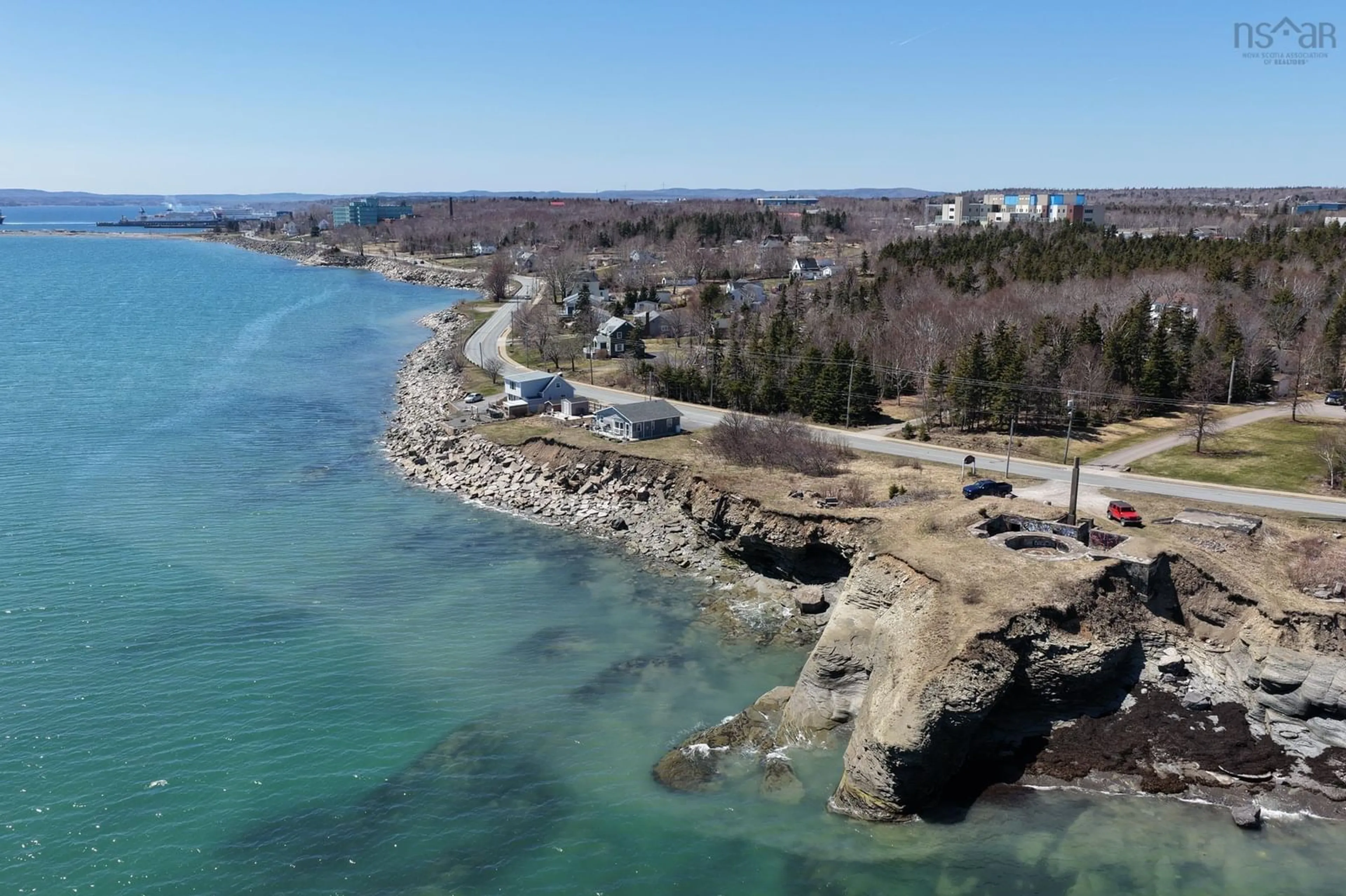 A pic from outside/outdoor area/front of a property/back of a property/a pic from drone, water/lake/river/ocean view for 675 Shore Rd, Sydney Mines Nova Scotia B1V 1A2