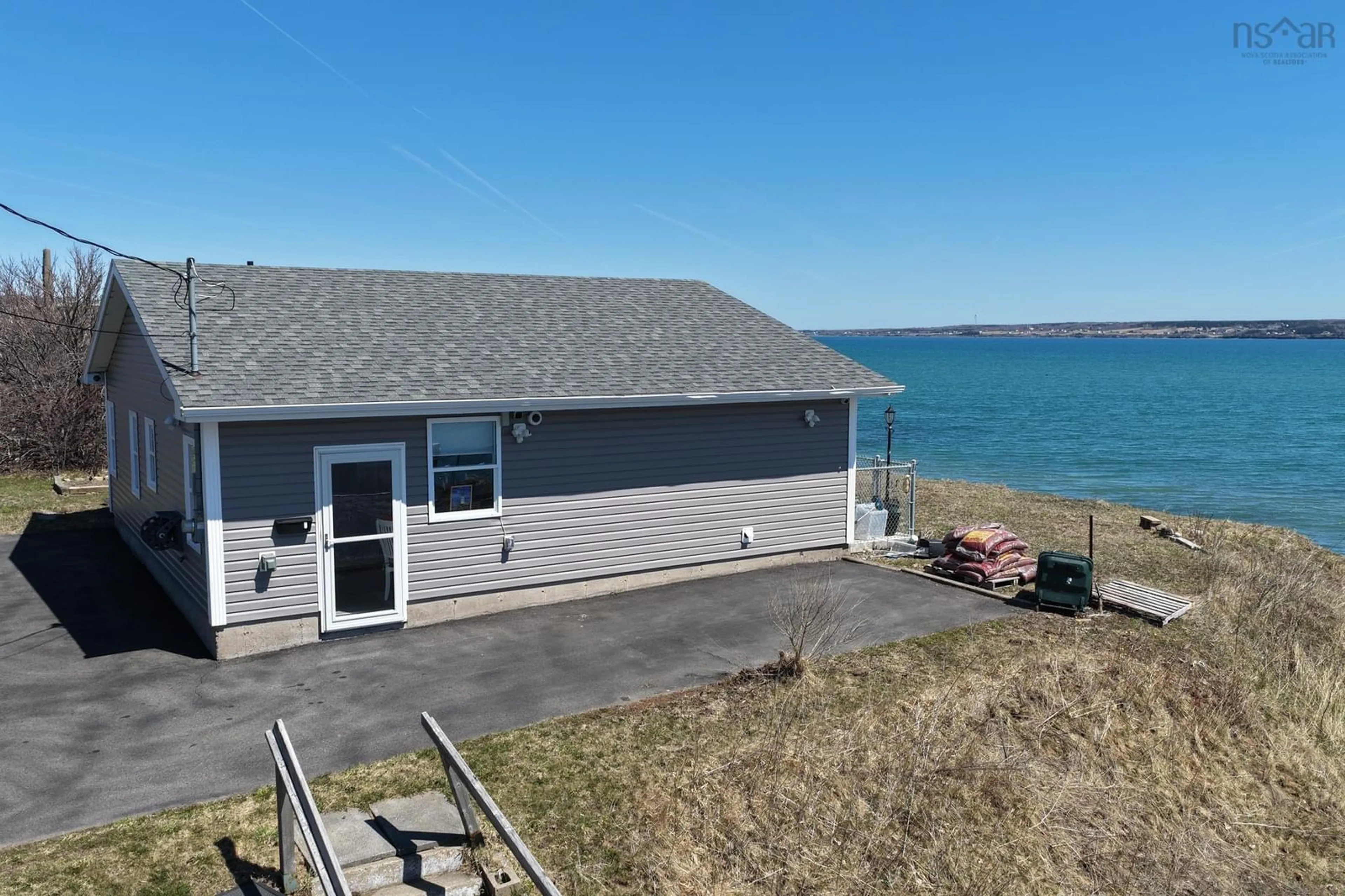 A pic from outside/outdoor area/front of a property/back of a property/a pic from drone, water/lake/river/ocean view for 675 Shore Rd, Sydney Mines Nova Scotia B1V 1A2
