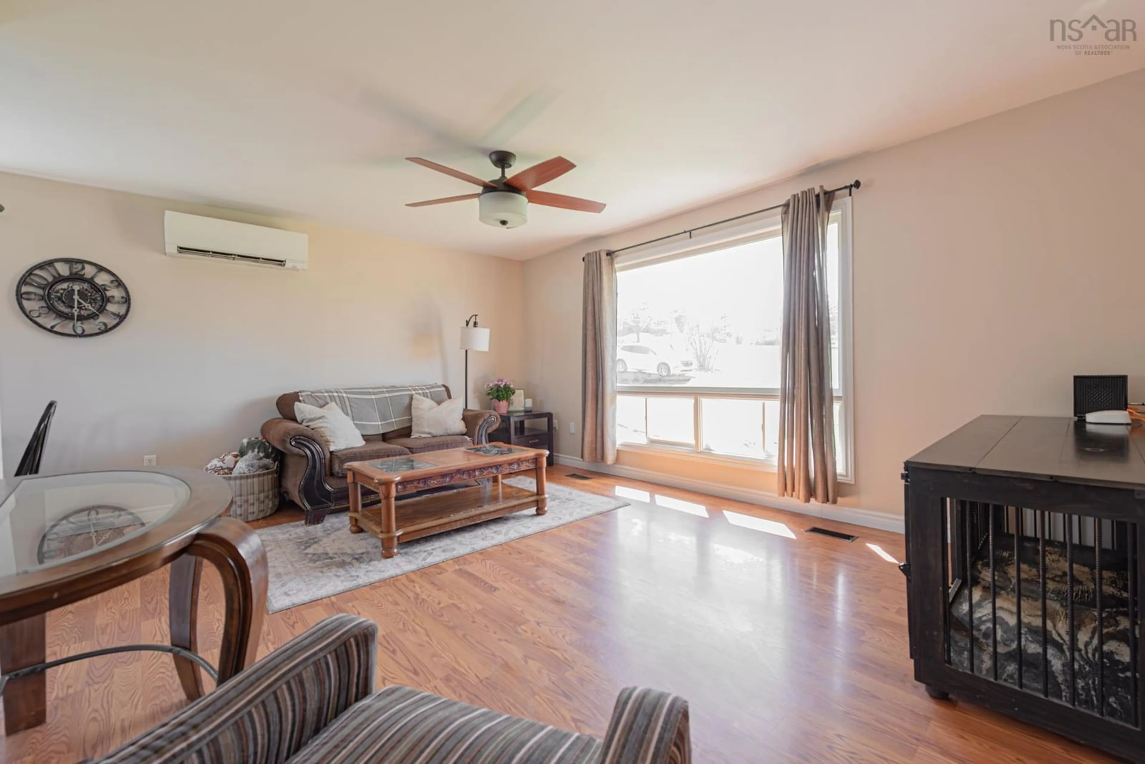 Living room with furniture, wood/laminate floor for 114 Mackenzie Rd, Mclellans Brook Nova Scotia B2H 5C7