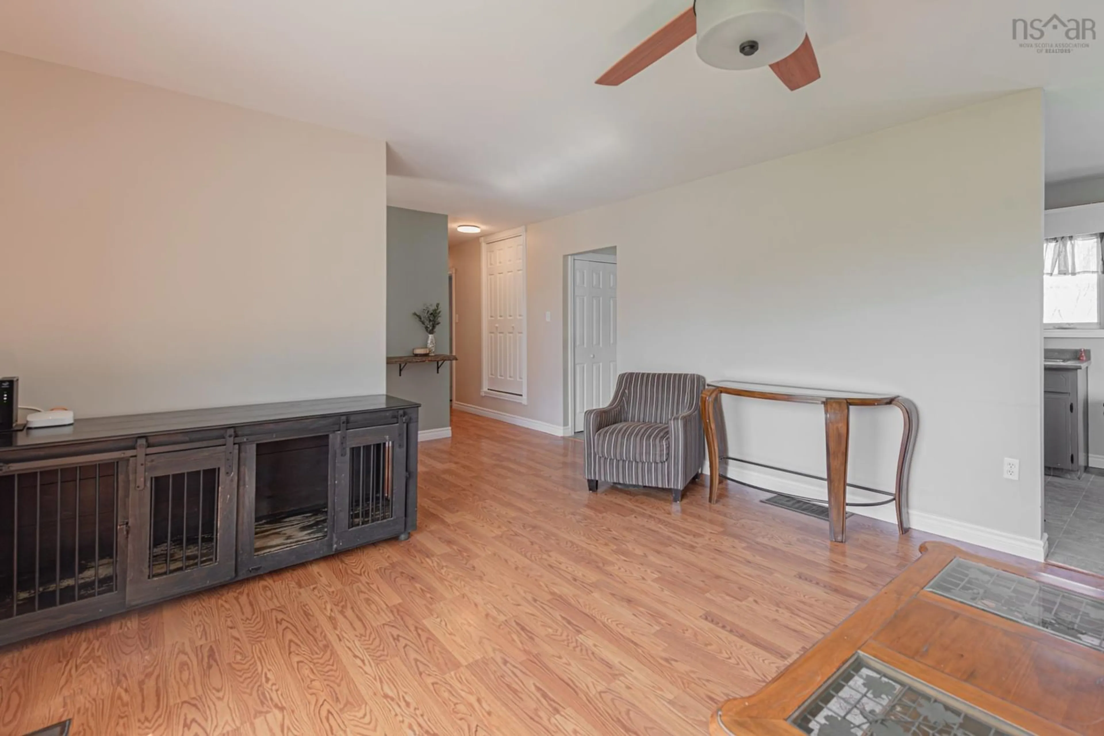 Living room with furniture, wood/laminate floor for 114 Mackenzie Rd, Mclellans Brook Nova Scotia B2H 5C7