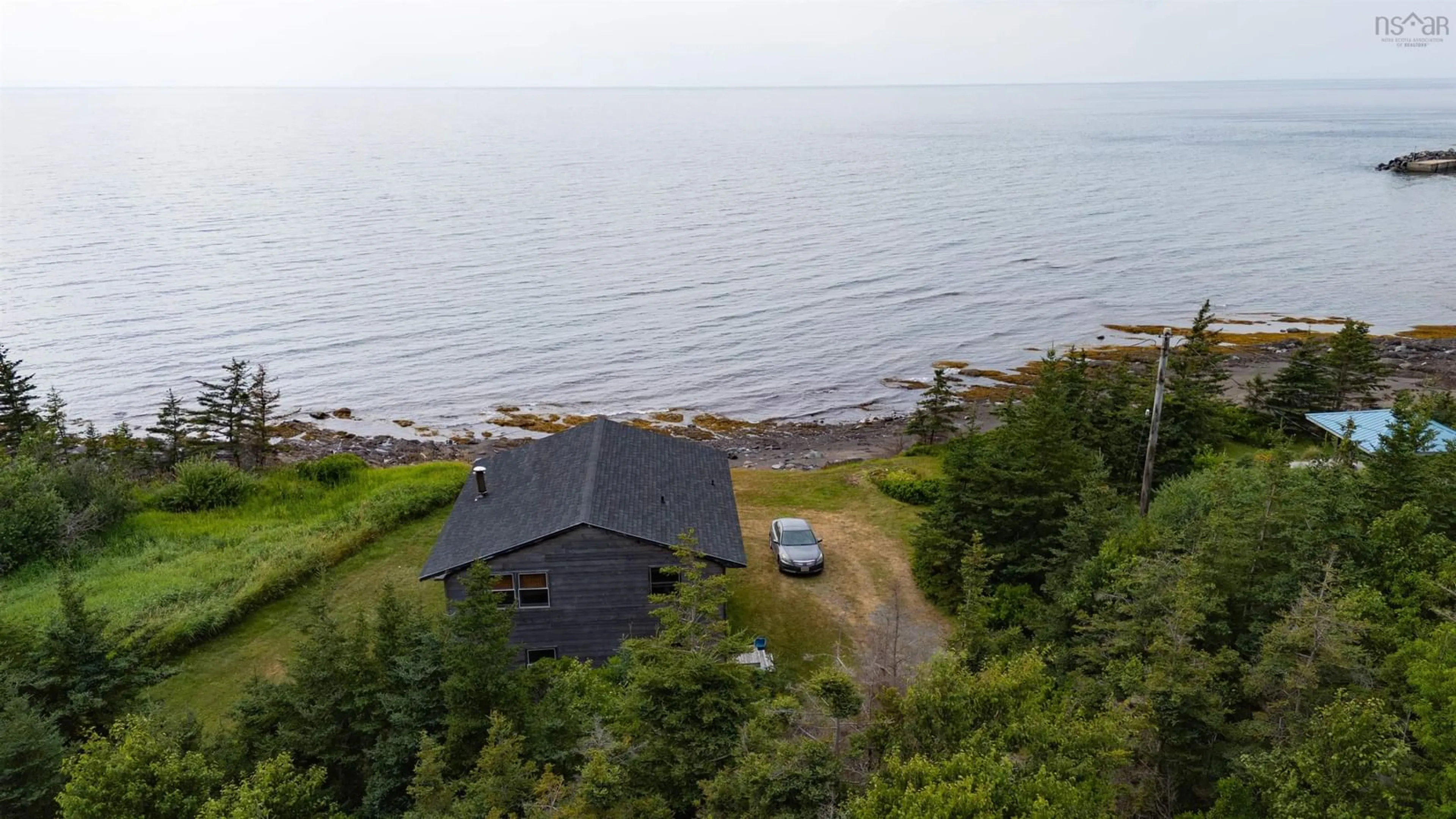 A pic from outside/outdoor area/front of a property/back of a property/a pic from drone, water/lake/river/ocean view for 83 Cottage Country Road, Livingstone Cove Nova Scotia B2G 2L1