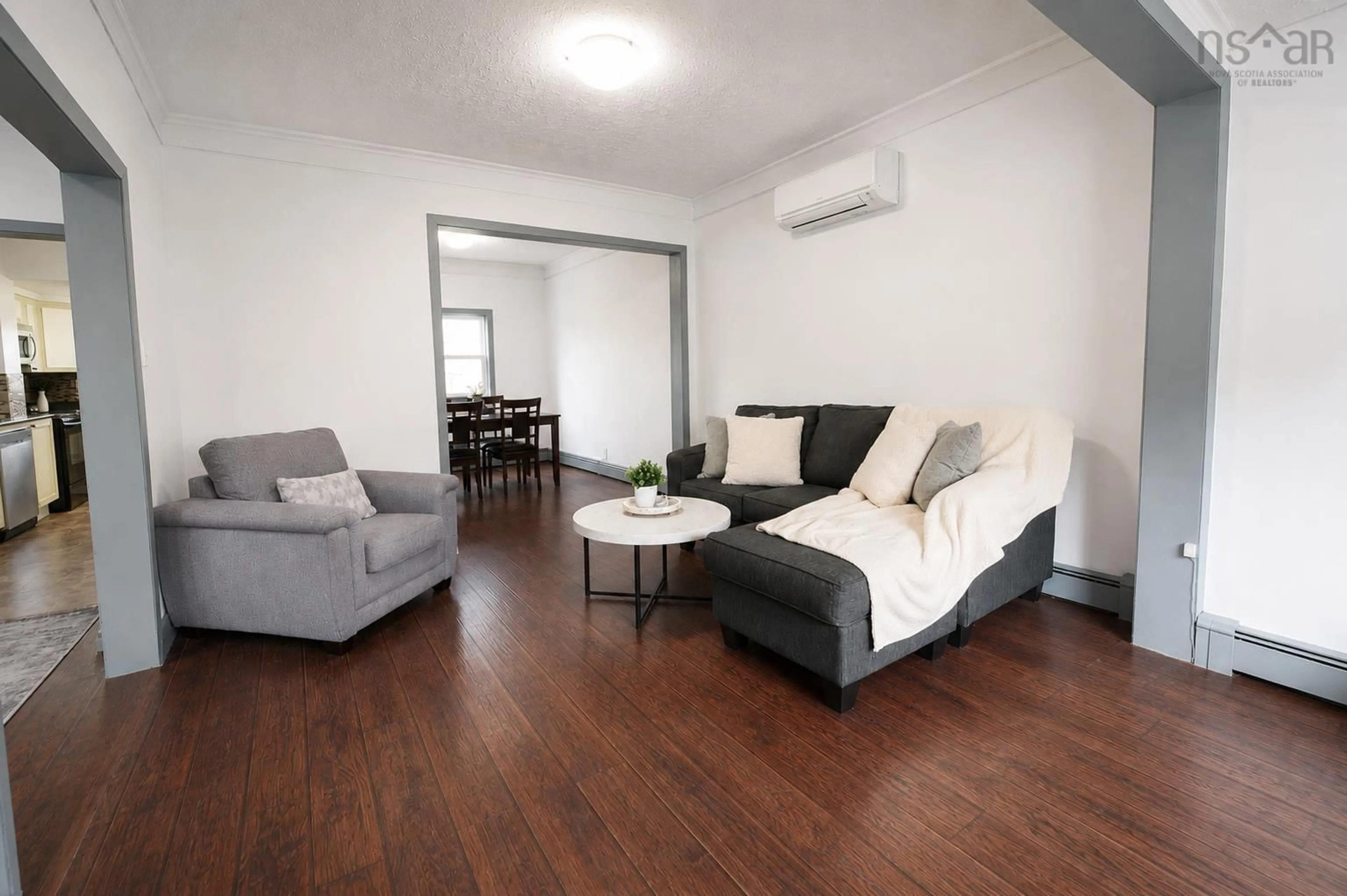 Living room with furniture, wood/laminate floor for 22 Rodney Rd, Dartmouth Nova Scotia B2Y 3V5