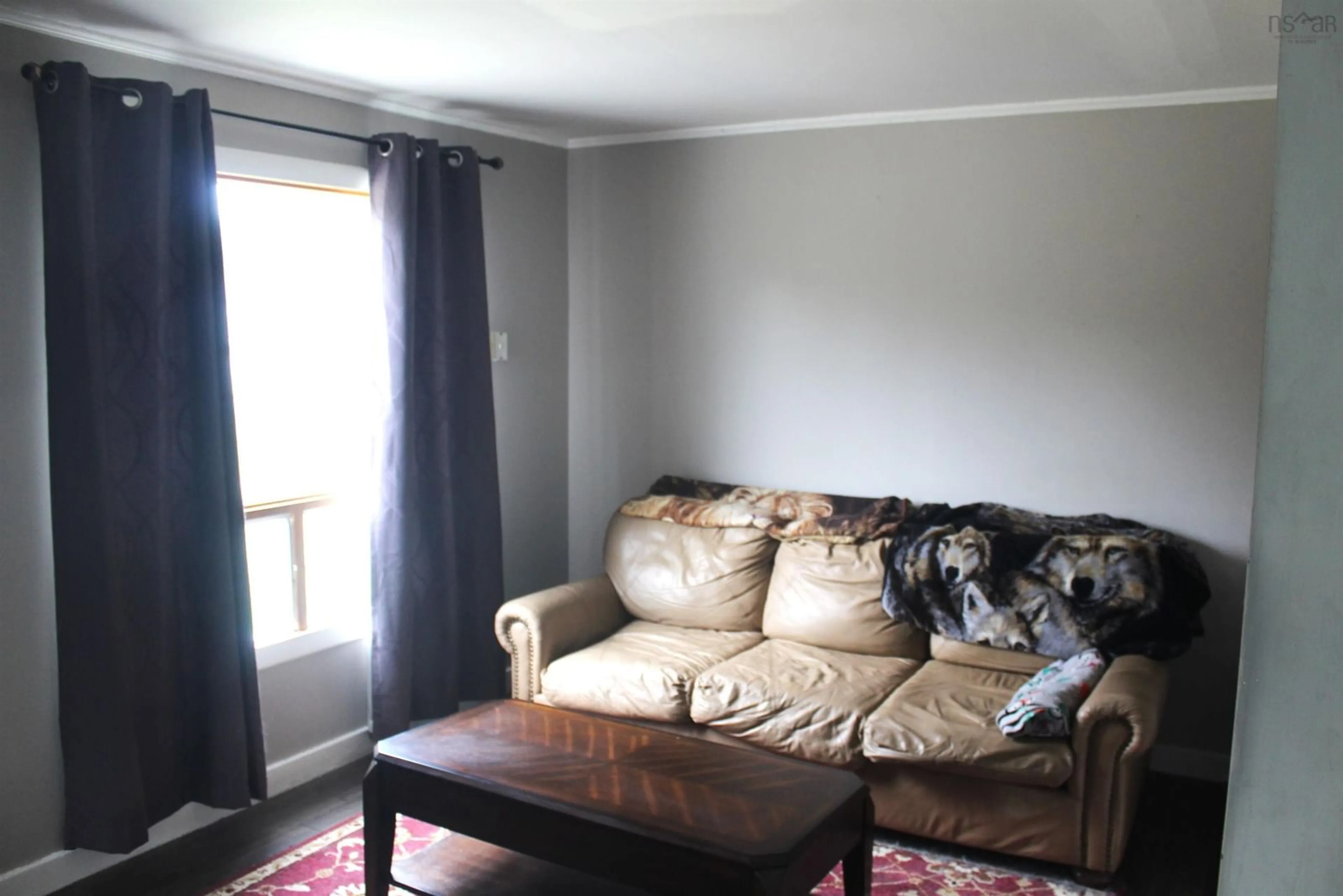 Living room with furniture, wood/laminate floor for 9916 St Margarets Bay Rd, Queensland Nova Scotia B0J 1T0