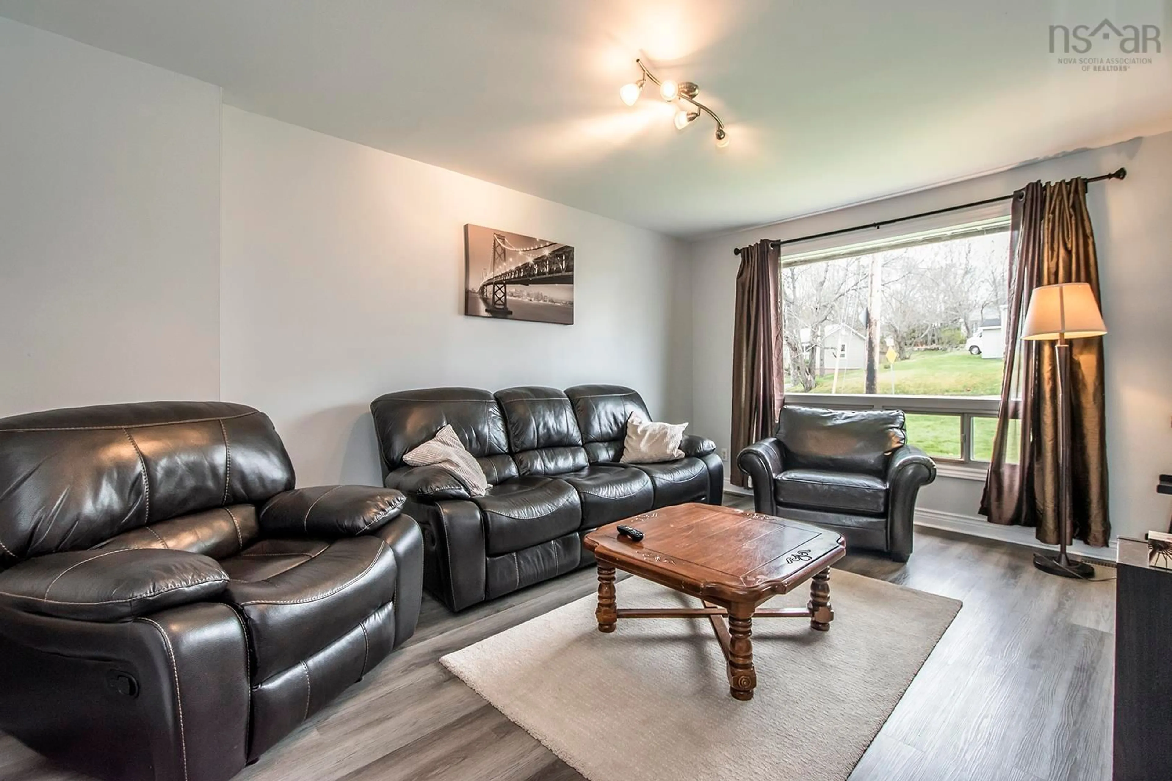 Living room with furniture, wood/laminate floor for 17 B&C Maple Dr, Woodlawn Nova Scotia B2X 1C1