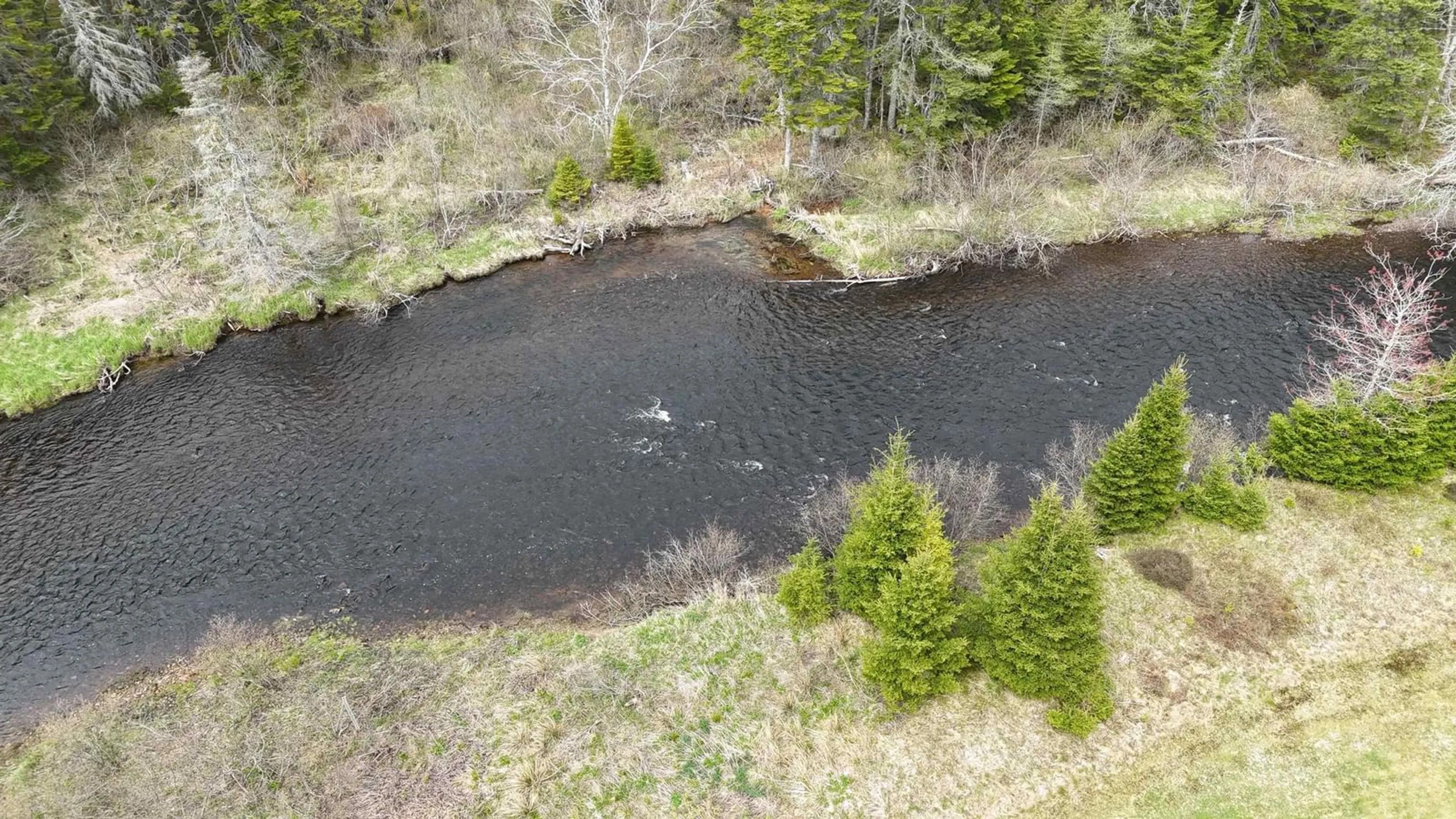 A pic from outside/outdoor area/front of a property/back of a property/a pic from drone, water/lake/river/ocean view for 1235 Loch Lomond Rd, Grand River Falls Nova Scotia B0E 1M0