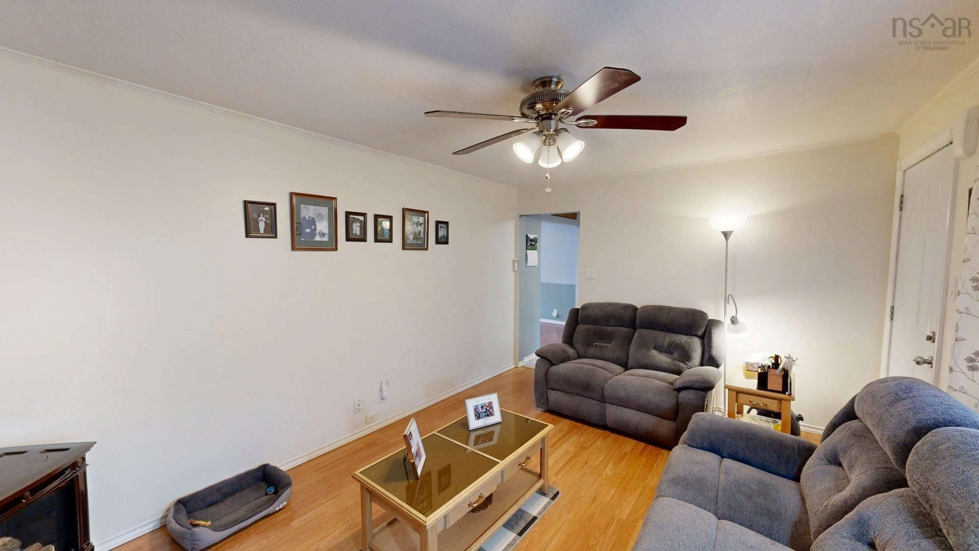 Living room with furniture, wood/laminate floor for 3095 Macleod Ave, River Ryan Nova Scotia B1H 1J6