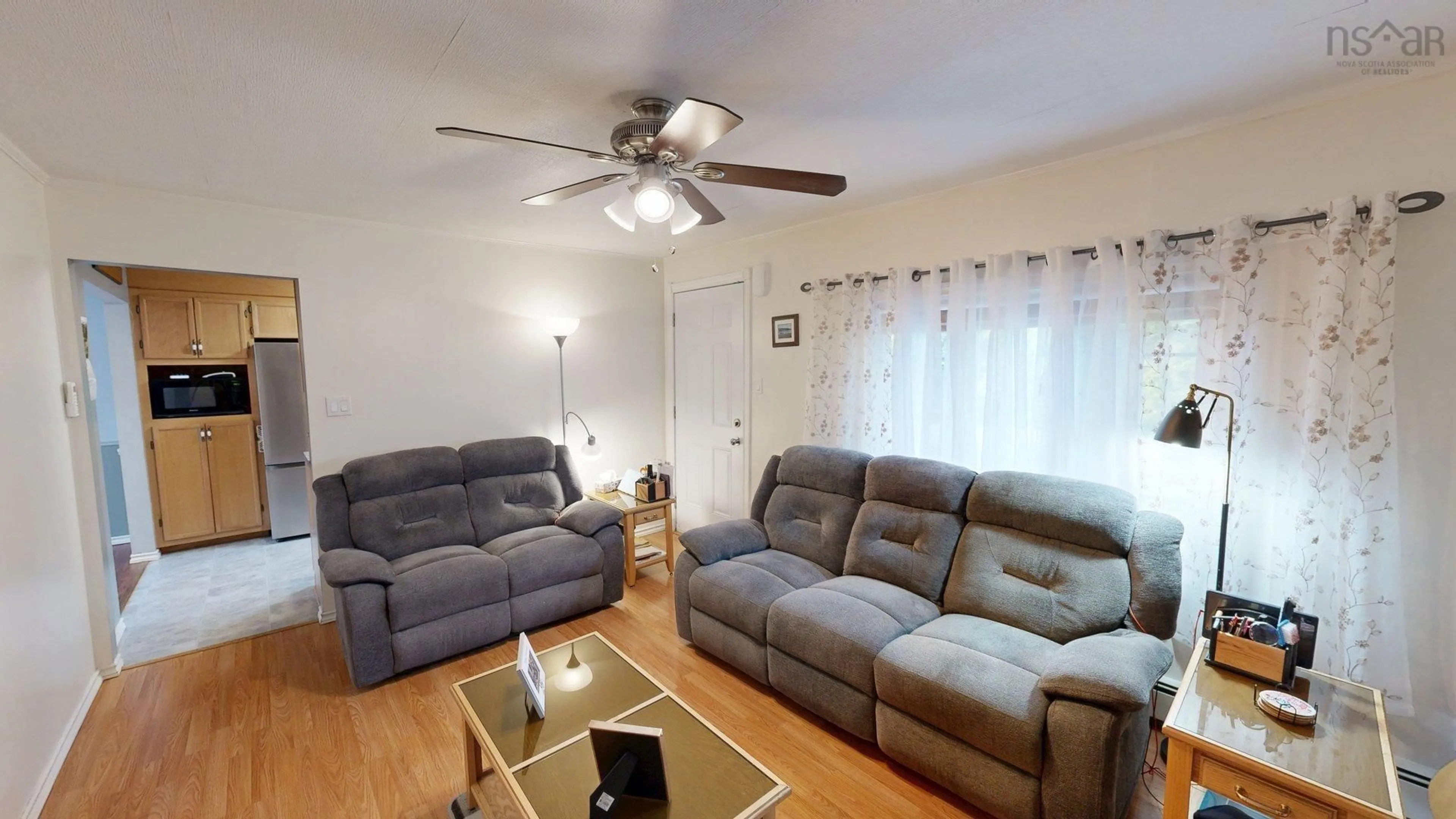Living room with furniture, wood/laminate floor for 3095 Macleod Ave, River Ryan Nova Scotia B1H 1J6