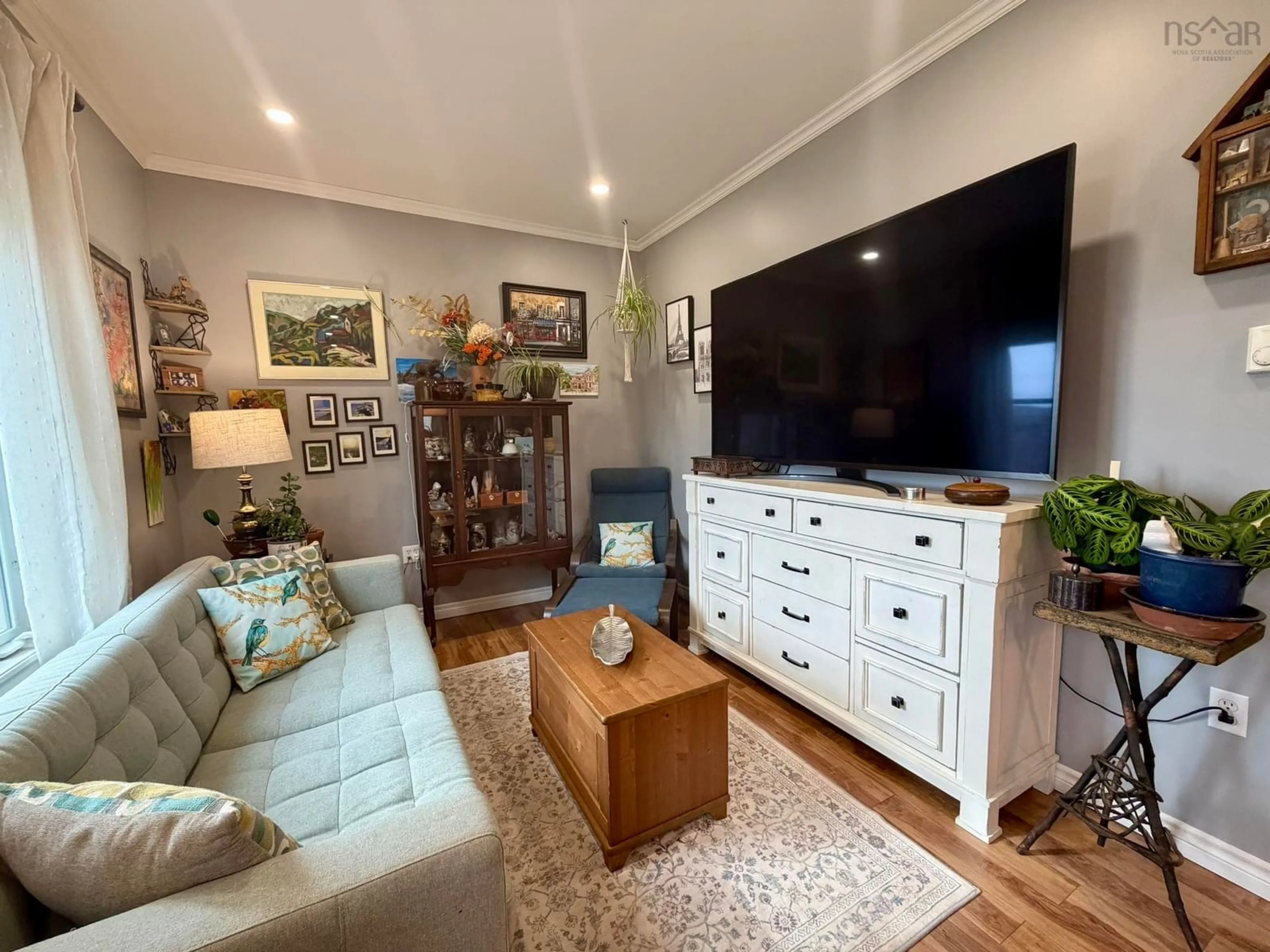 Living room with furniture, wood/laminate floor for 9384 Highway 7, Stillwater Nova Scotia B0H 1E0