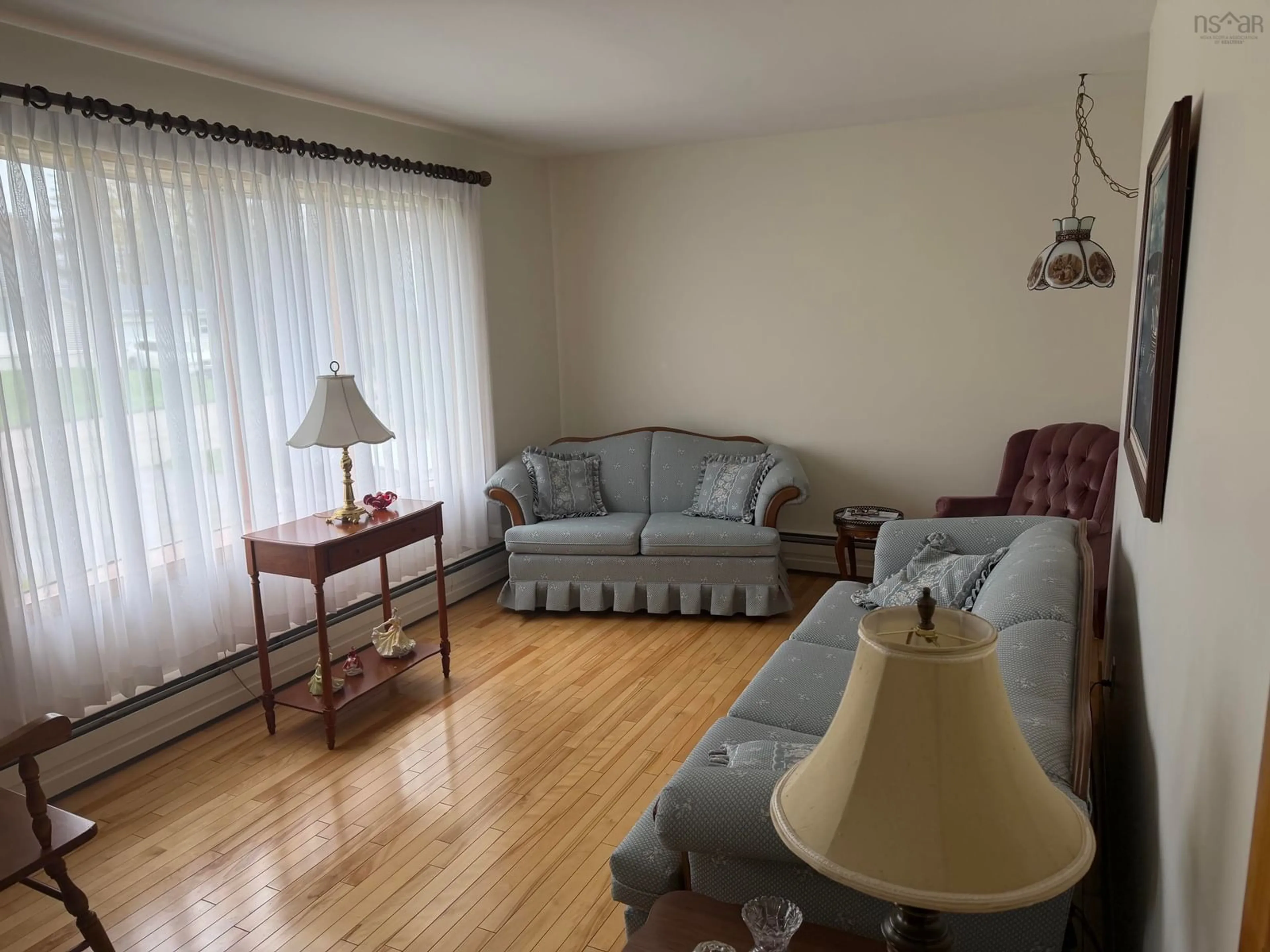 Living room with furniture, wood/laminate floor for 75 Waterview Dr, Coxheath Nova Scotia B1R 1S7