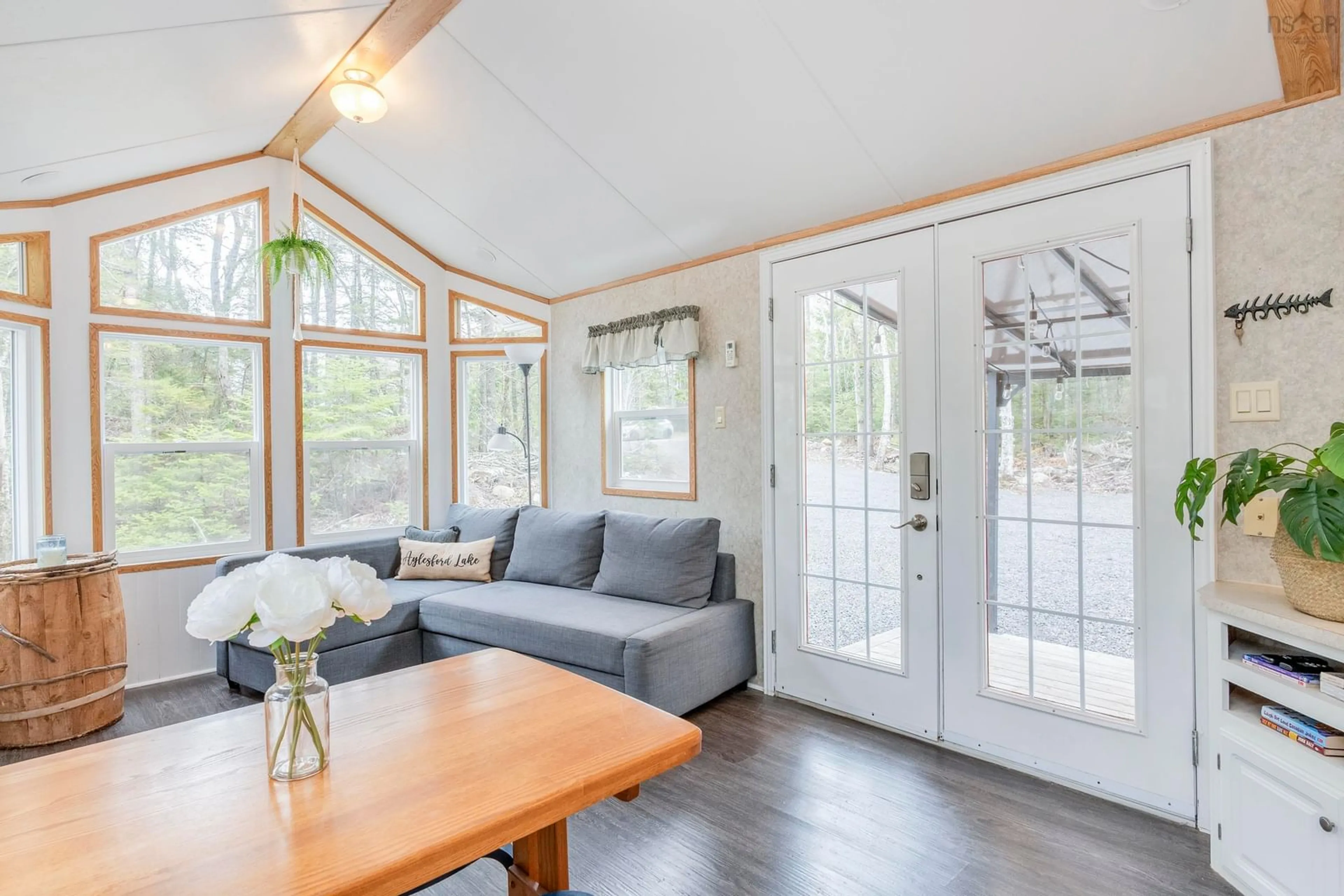 Living room with furniture, wood/laminate floor for 18 Loon Lane, Aylesford Lake Nova Scotia B0P 1C0