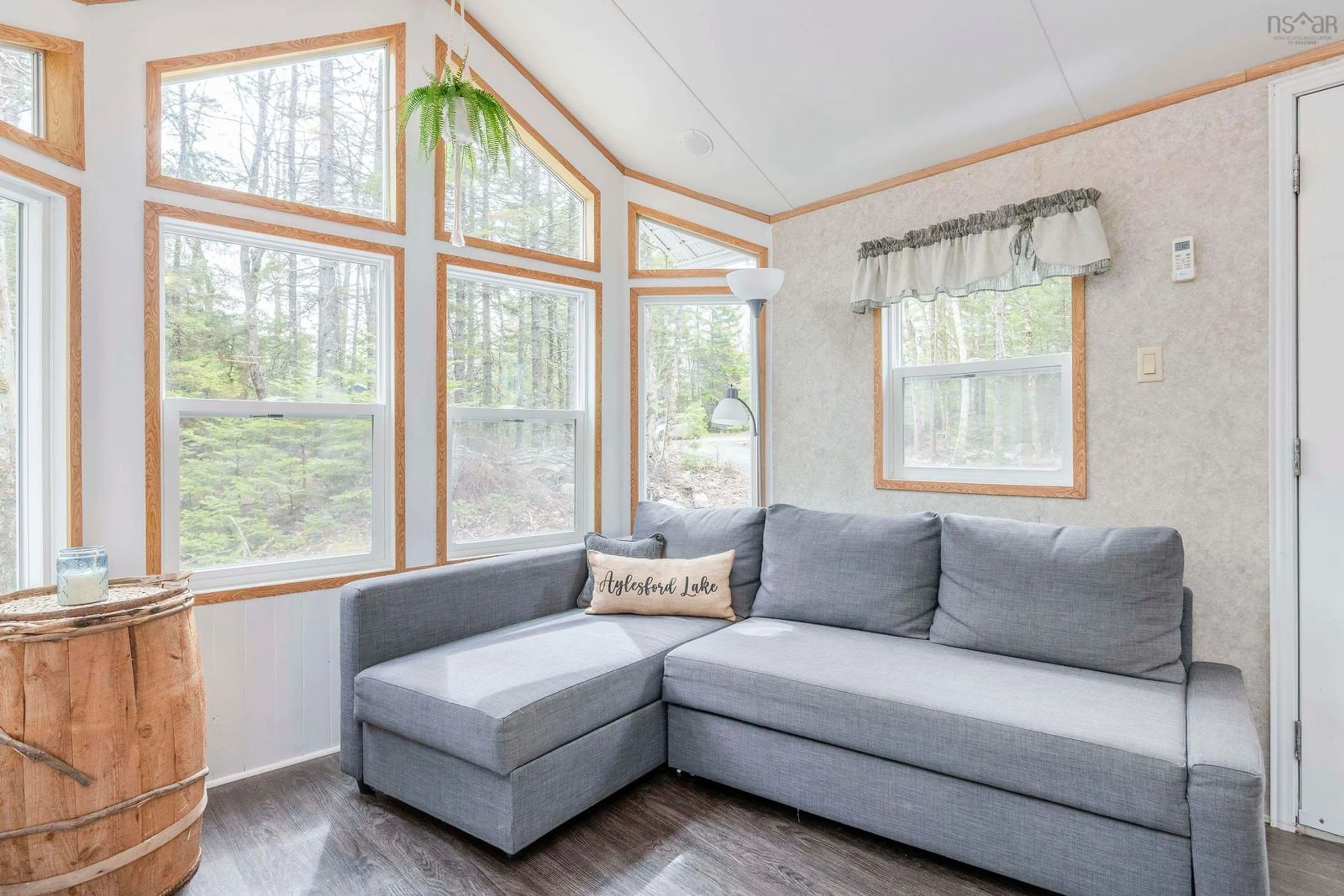 Living room with furniture, wood/laminate floor for 18 Loon Lane, Aylesford Lake Nova Scotia B0P 1C0