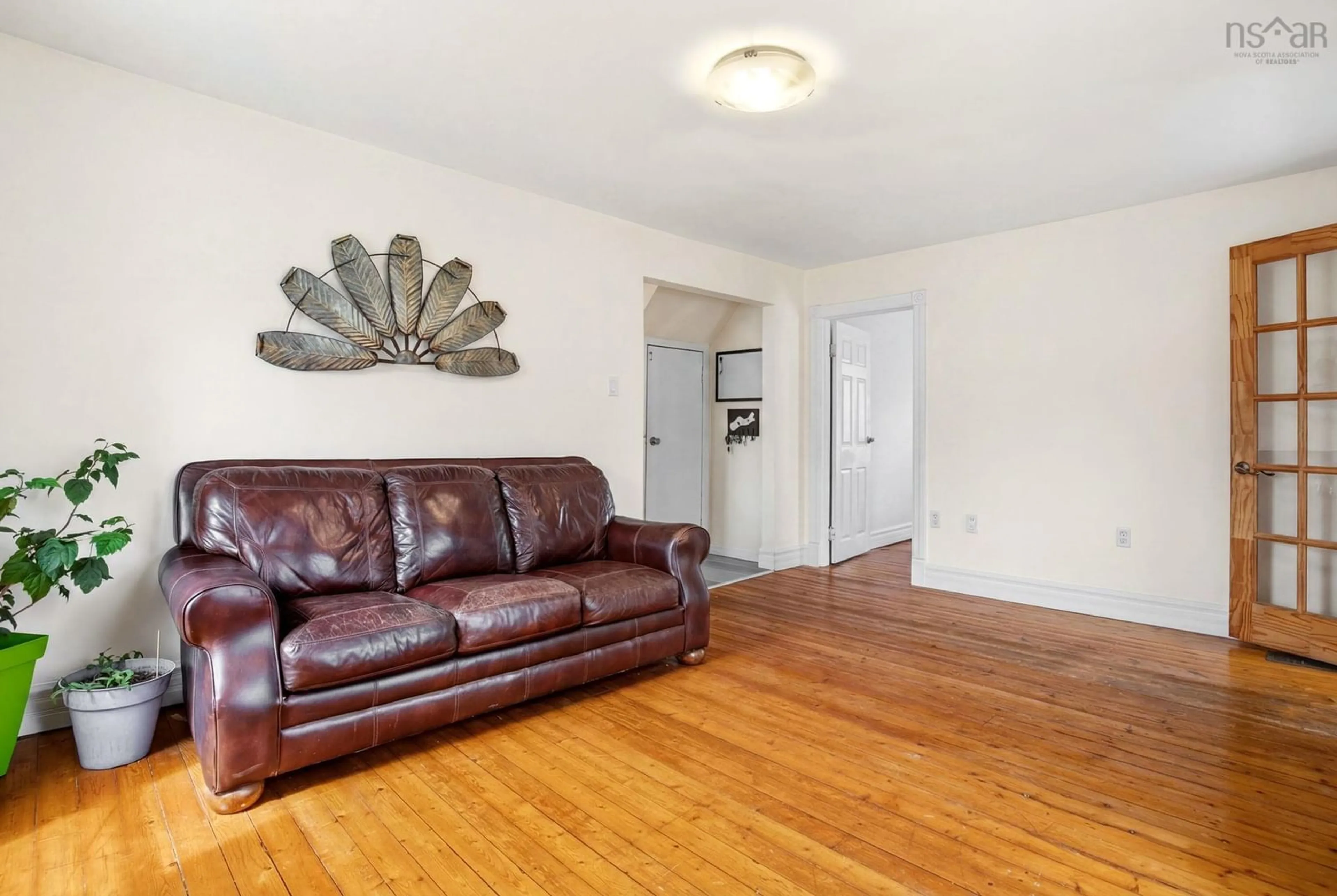 Living room with furniture, wood/laminate floor for 27 Stone Terr, Bedford Nova Scotia B4A 2G7