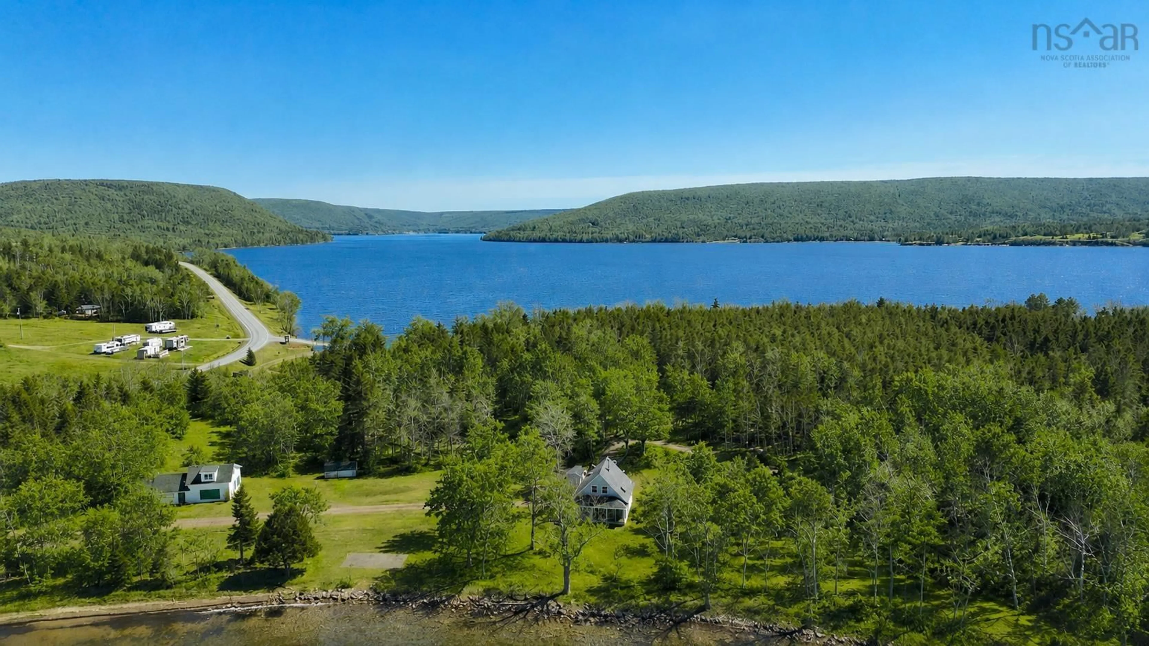 A pic from outside/outdoor area/front of a property/back of a property/a pic from drone, water/lake/river/ocean view for 348 395 Highway, East Lake Ainslie Nova Scotia B0E 3M0