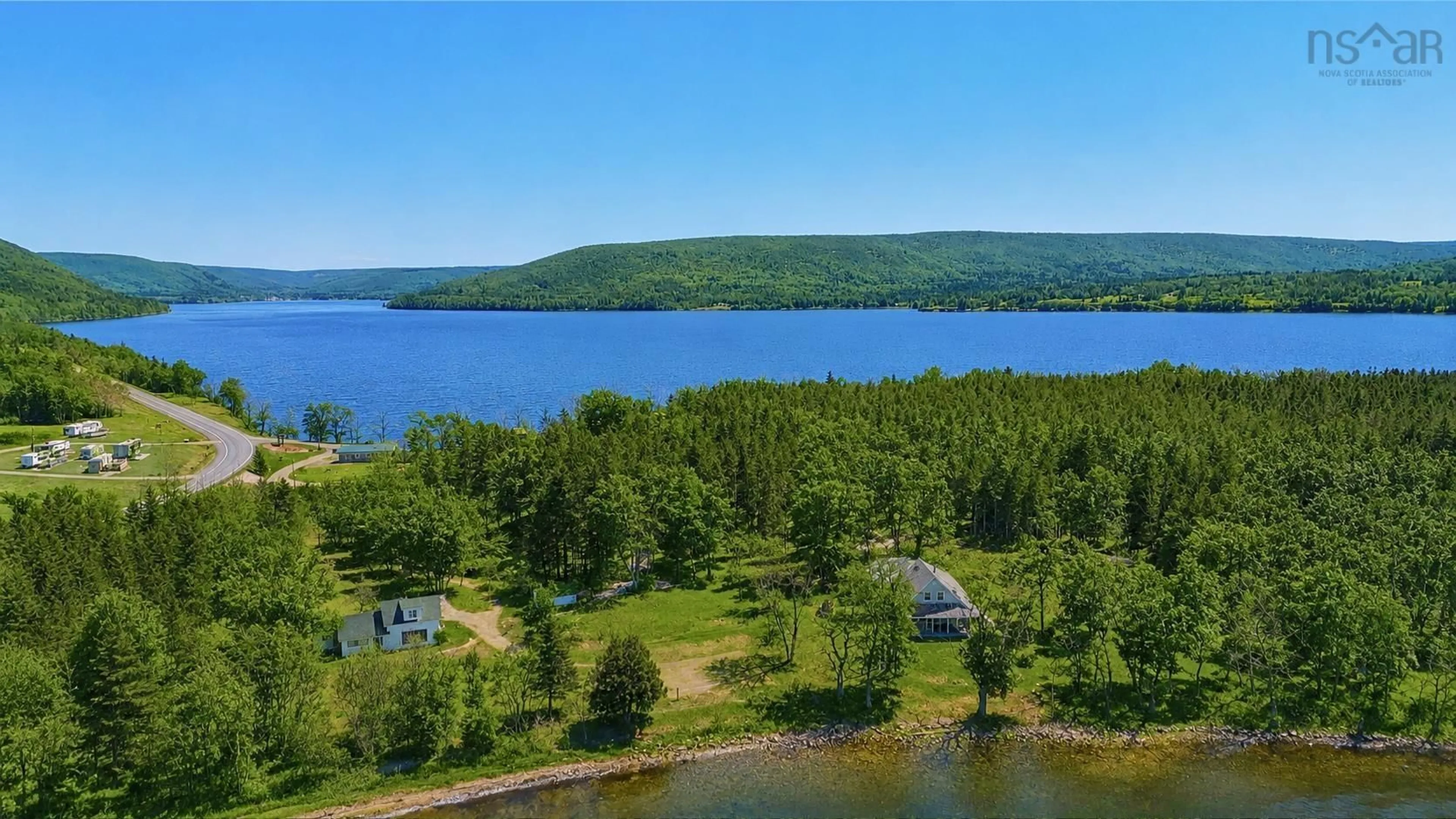 A pic from outside/outdoor area/front of a property/back of a property/a pic from drone, water/lake/river/ocean view for 348 395 Highway, East Lake Ainslie Nova Scotia B0E 3M0