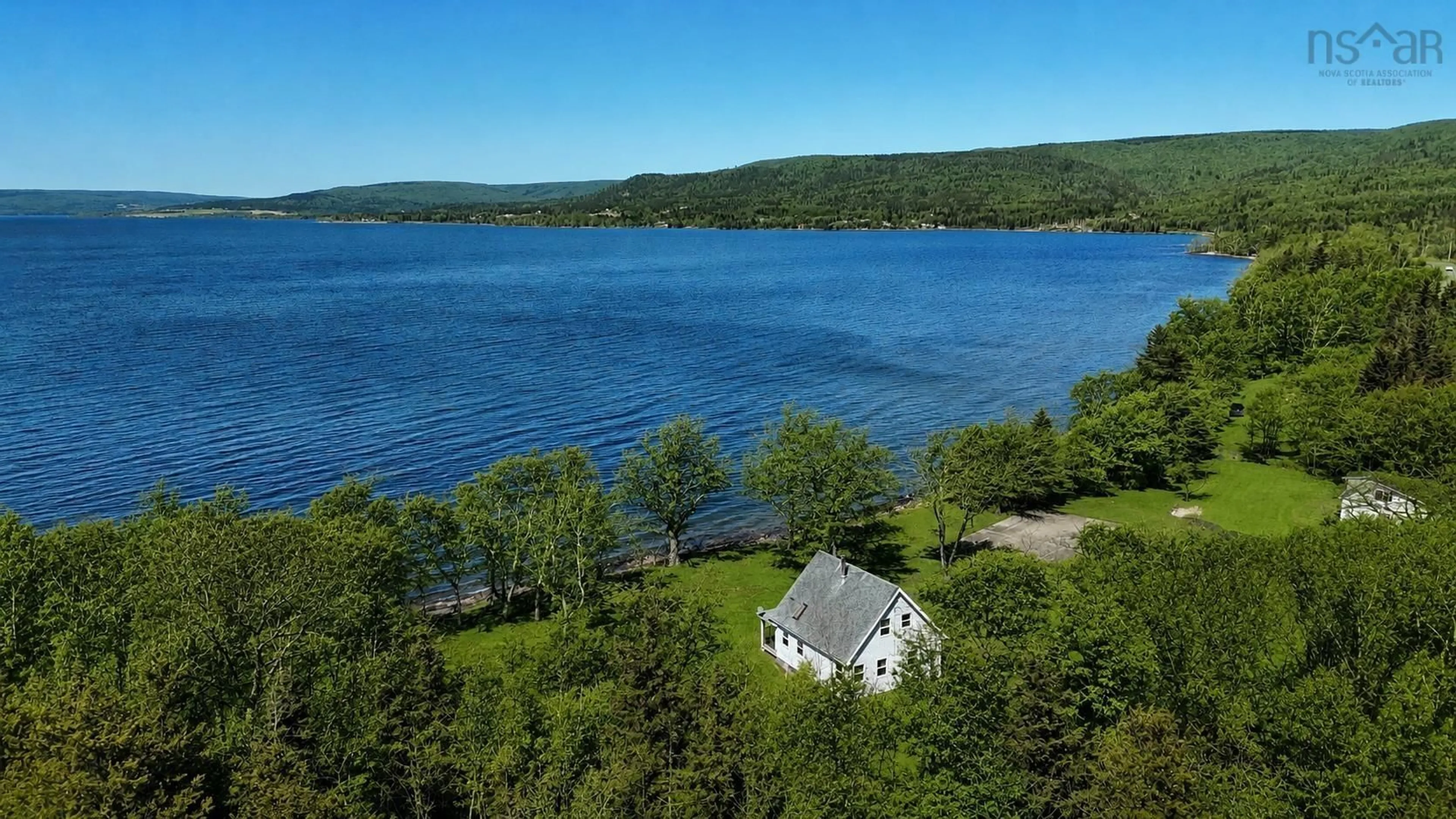 A pic from outside/outdoor area/front of a property/back of a property/a pic from drone, water/lake/river/ocean view for 348 395 Highway, East Lake Ainslie Nova Scotia B0E 3M0