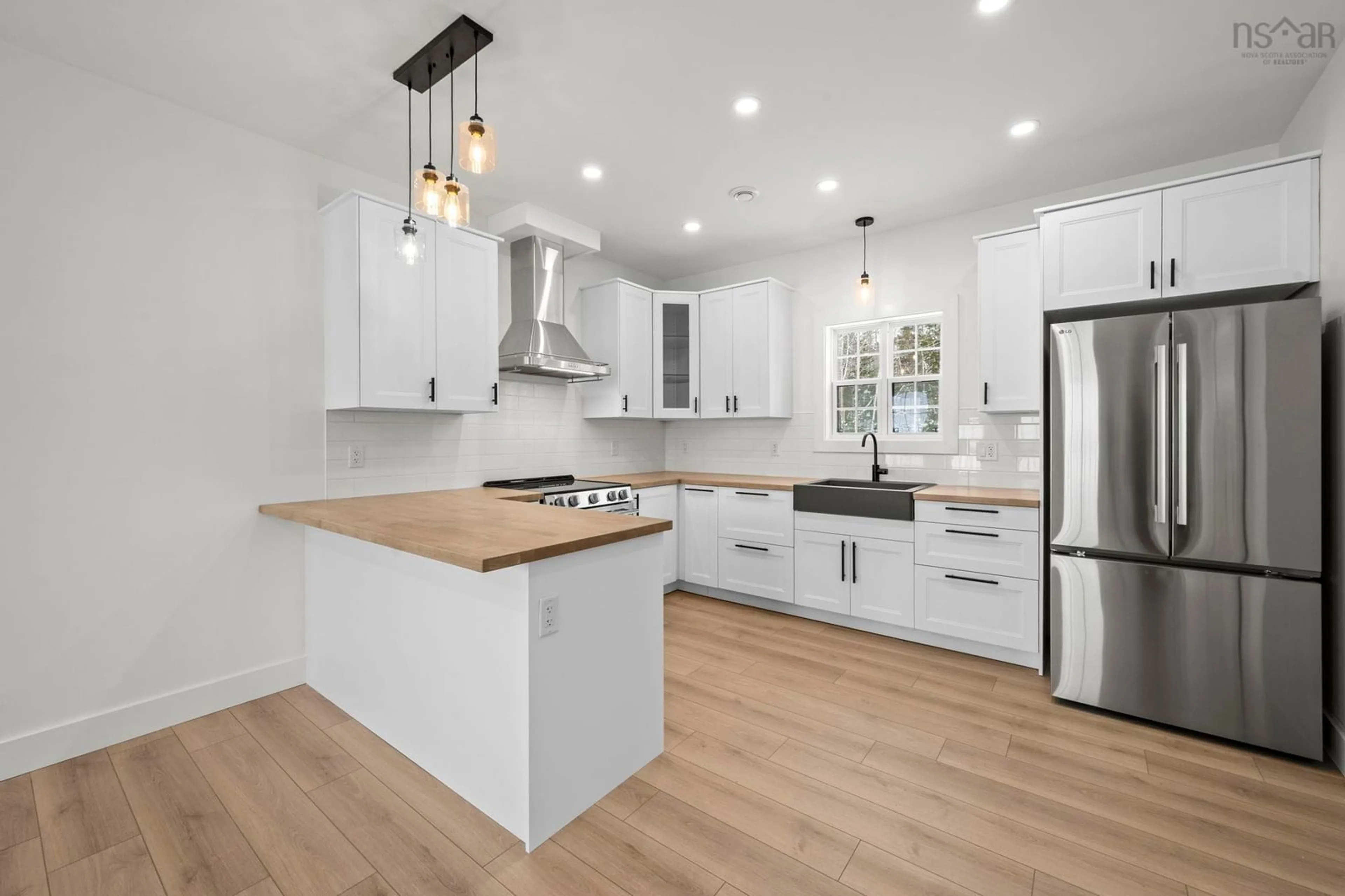 Open concept kitchen, wood/laminate floor for 67 Birchview Dr, Lake Charlotte Nova Scotia B0J 2L0