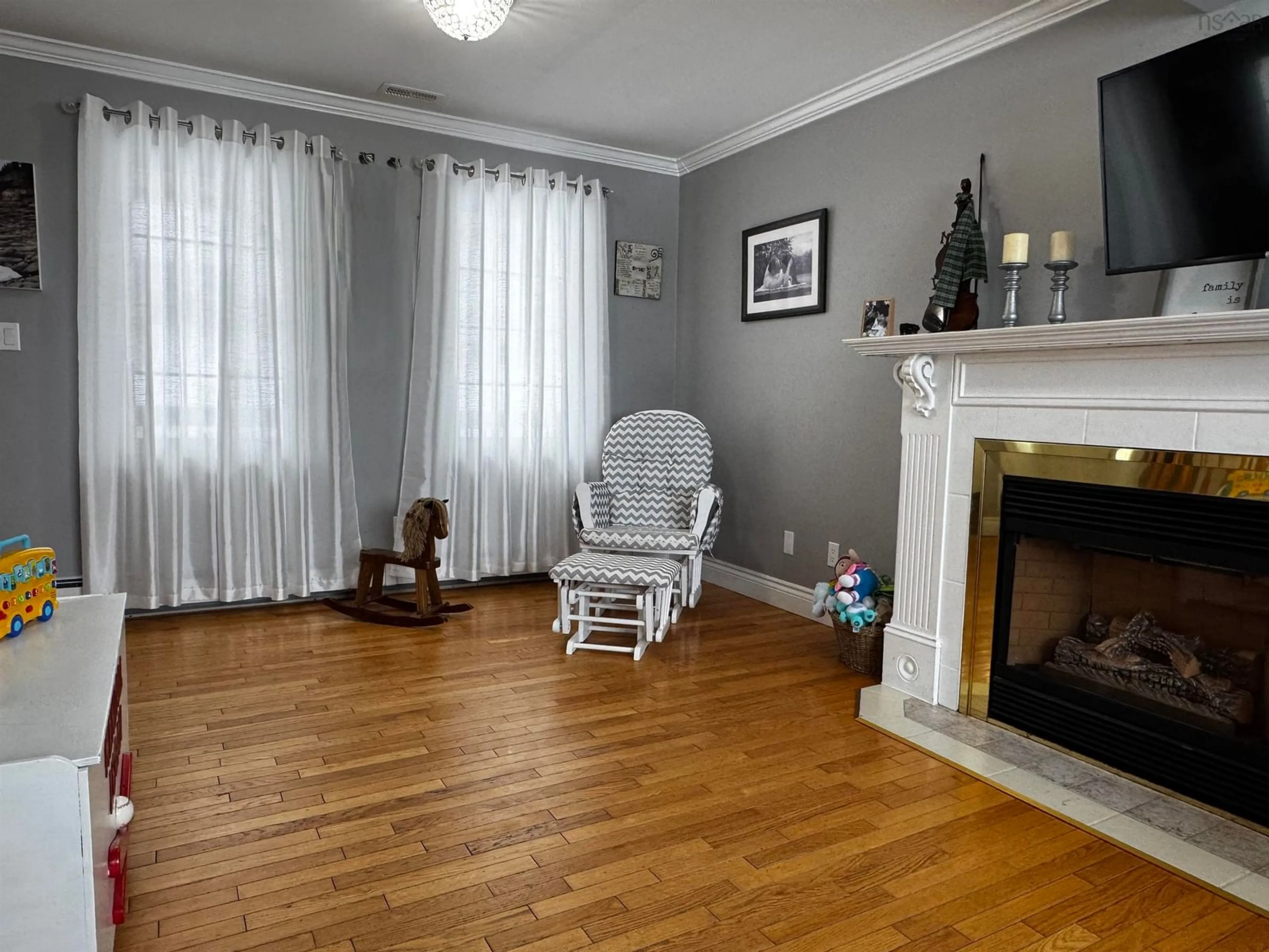 Living room with furniture, wood/laminate floor for 33 Turnbull St, Dominion Nova Scotia B1G 1W5