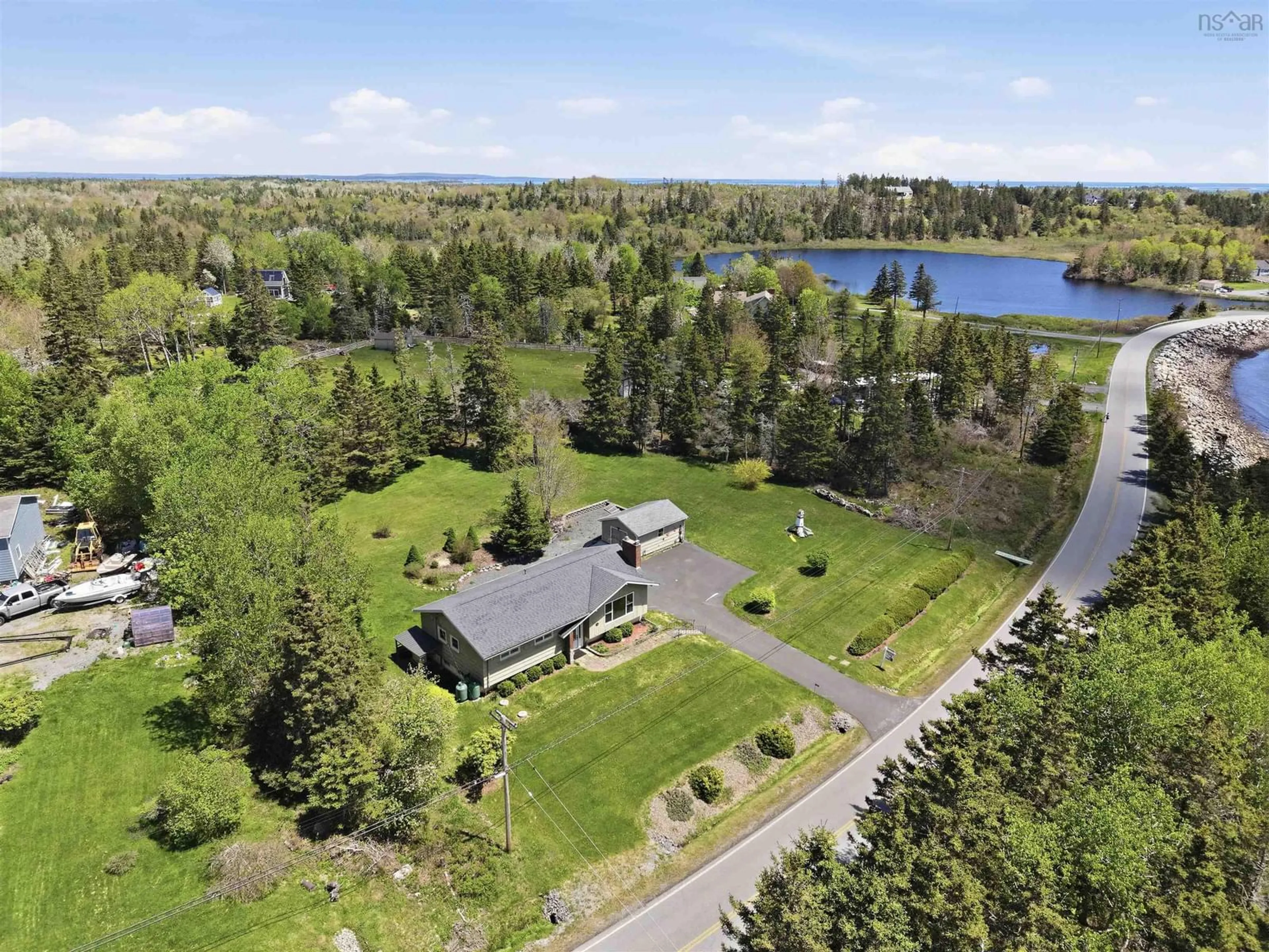 A pic from outside/outdoor area/front of a property/back of a property/a pic from drone, water/lake/river/ocean view for 1157 Blue Rocks Rd, Blue Rocks Nova Scotia B0J 2C0