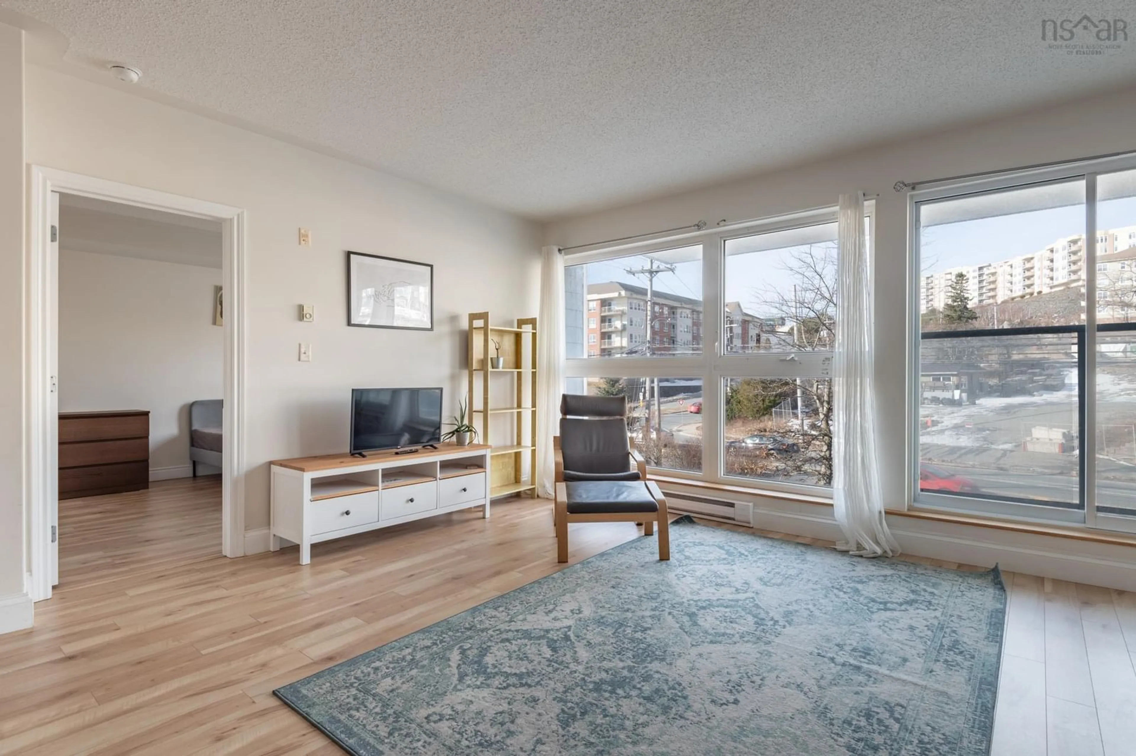 Living room with furniture, wood/laminate floor for 647 Bedford Hwy #208, Halifax Nova Scotia B3M 0A5