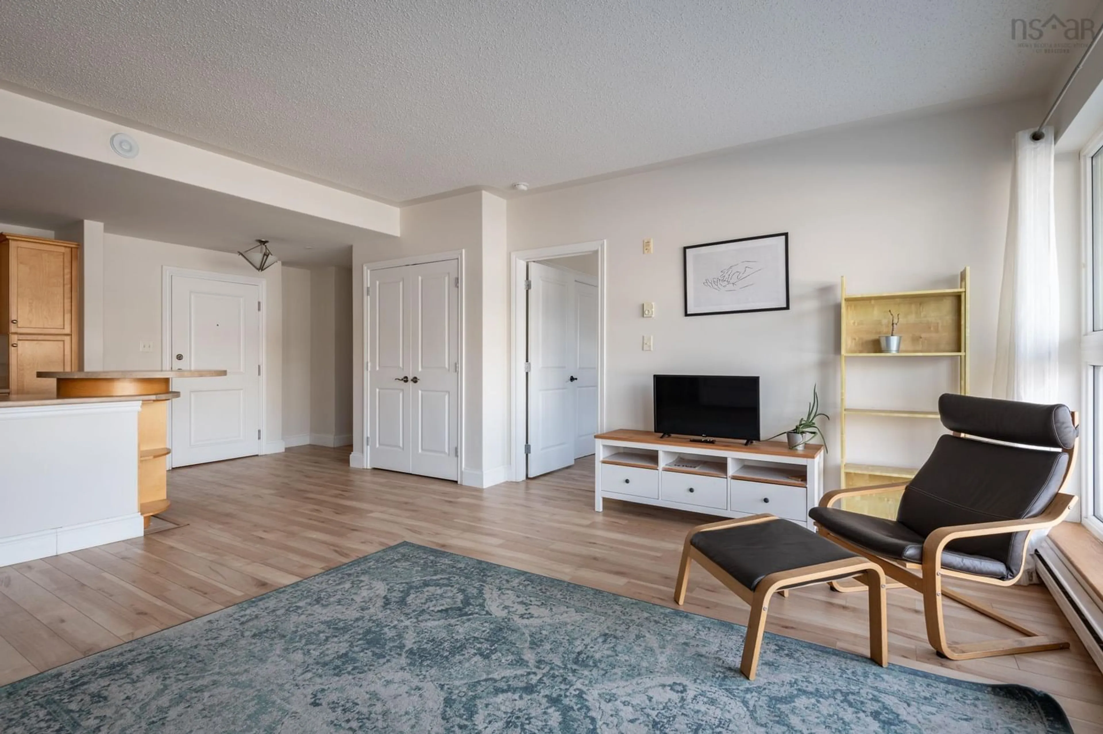 Living room with furniture, wood/laminate floor for 647 Bedford Hwy #208, Halifax Nova Scotia B3M 0A5