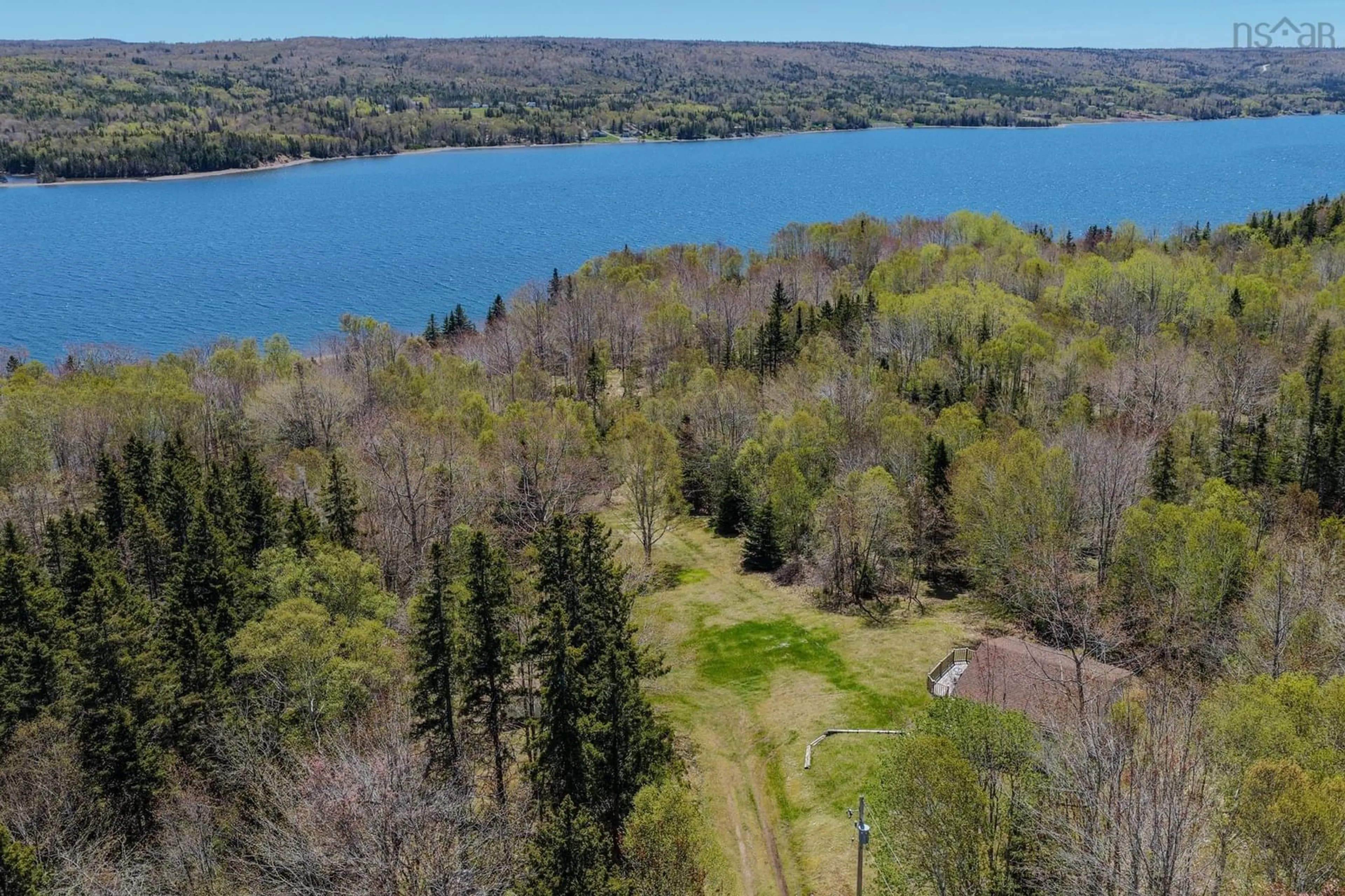 A pic from outside/outdoor area/front of a property/back of a property/a pic from drone, water/lake/river/ocean view for 81 Maceachern Rd, North Side East Bay Nova Scotia B1J 1E4