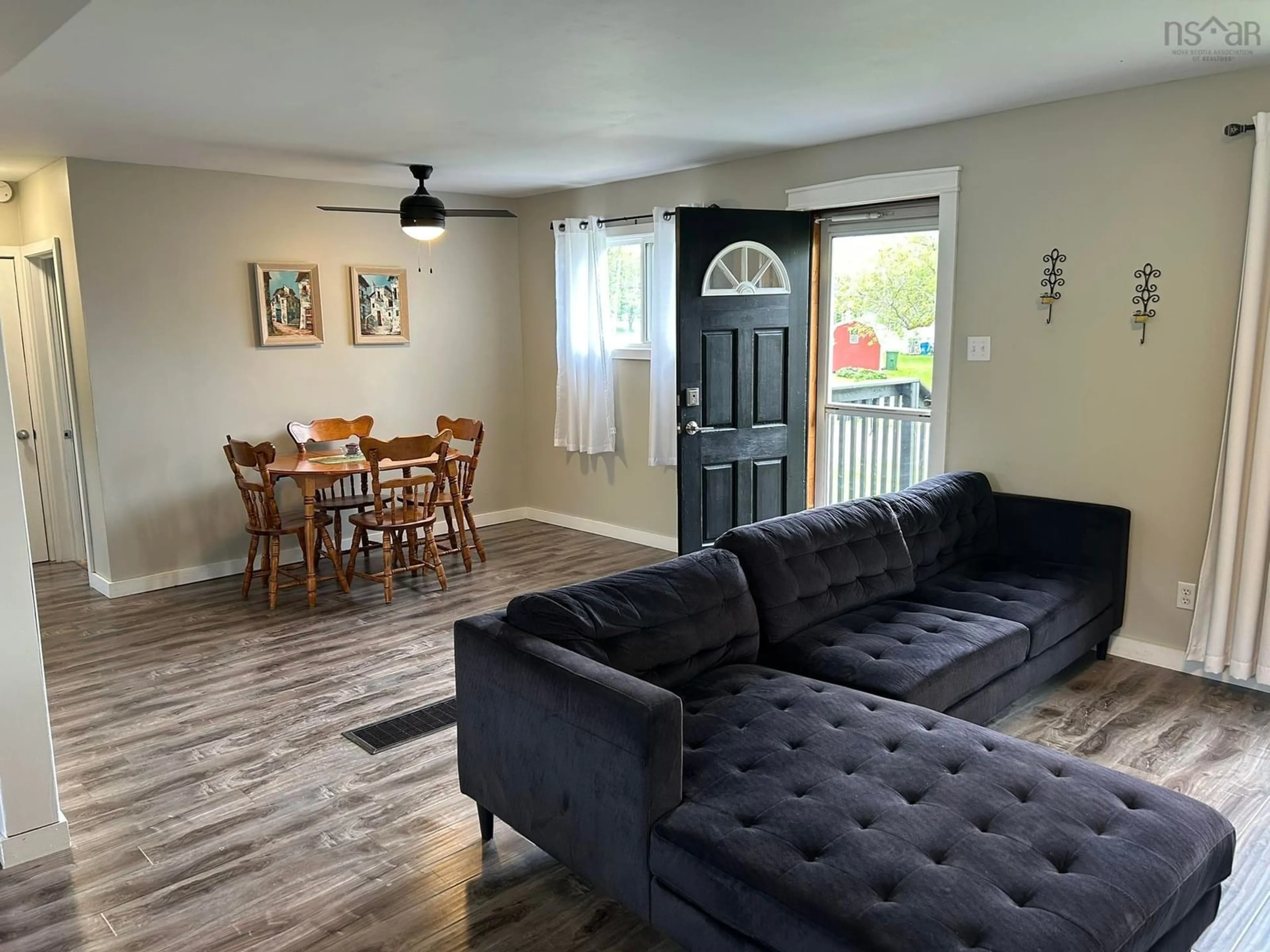 Living room with furniture, wood/laminate floor for 23 Snowden Ave, Amherst Nova Scotia B4H 2N1
